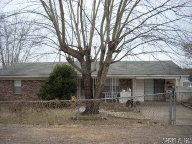 Home is located close to Walmart and Arkansas Tech University and minutes from downtown. It features a new roof, new heating and air system. There is a two story workshop with power in back yard on concrete pad. Lot has ingress and egress on two streets. Currently renters living there so 24 hour notice is required for showing. To schedule appointment please call listing agent Ray Lawless @ 479-209-6125 or office @ 479-667-2159.