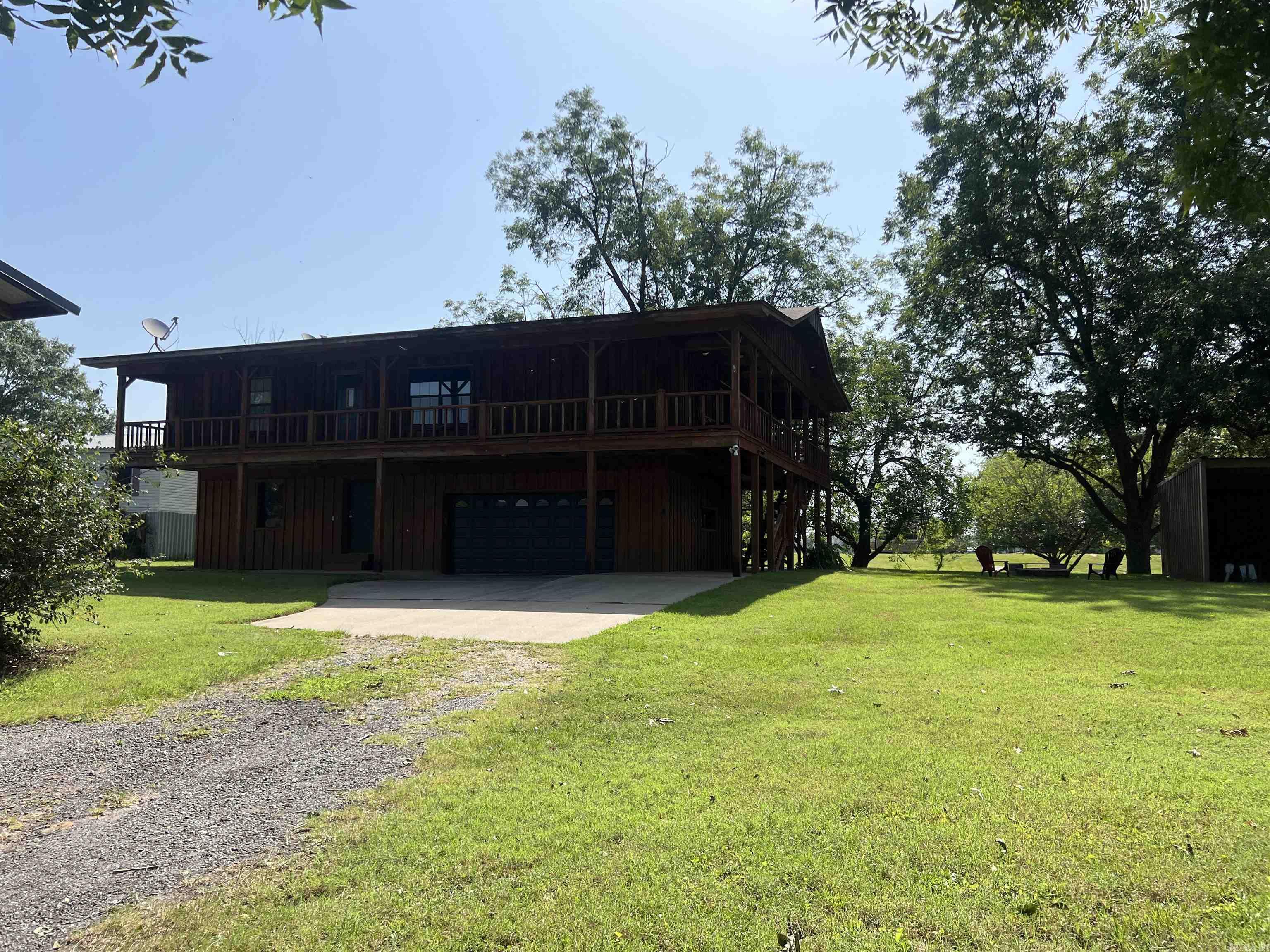 Nicely maintained 4 Bed 3 Bath house on a canal of the Arkansas River. This home has 3 bedrooms and 2 remodeled baths upstairs, a great room, large remodeled kitchen with breakfast bar and dining room. The lower level has a living area, bath and laundry room and garage. The roof is less than ten years old and has a newer water heater. The updated flooring and water HVAC unit is newer as well. This home has a wrap around porch on three sides perfect for a beautiful view of the water.