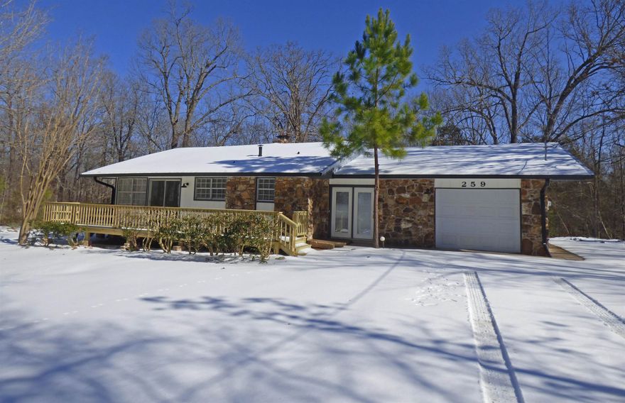 Beautiful 3 Bedroom House - Totally  Remodeled! Come home to this 3 bedroom, 2 bath house with new flooring and interior paint throughout, new fixtures, new metal  roof, new stainless appliances, wood burning fireplace in an open living/dining room combo. Move in today with a brand new deck, two storage buildings, and one-car garage. All this on two flat lots in a great location not far from many amenities in Beautiful Cherokee Village.