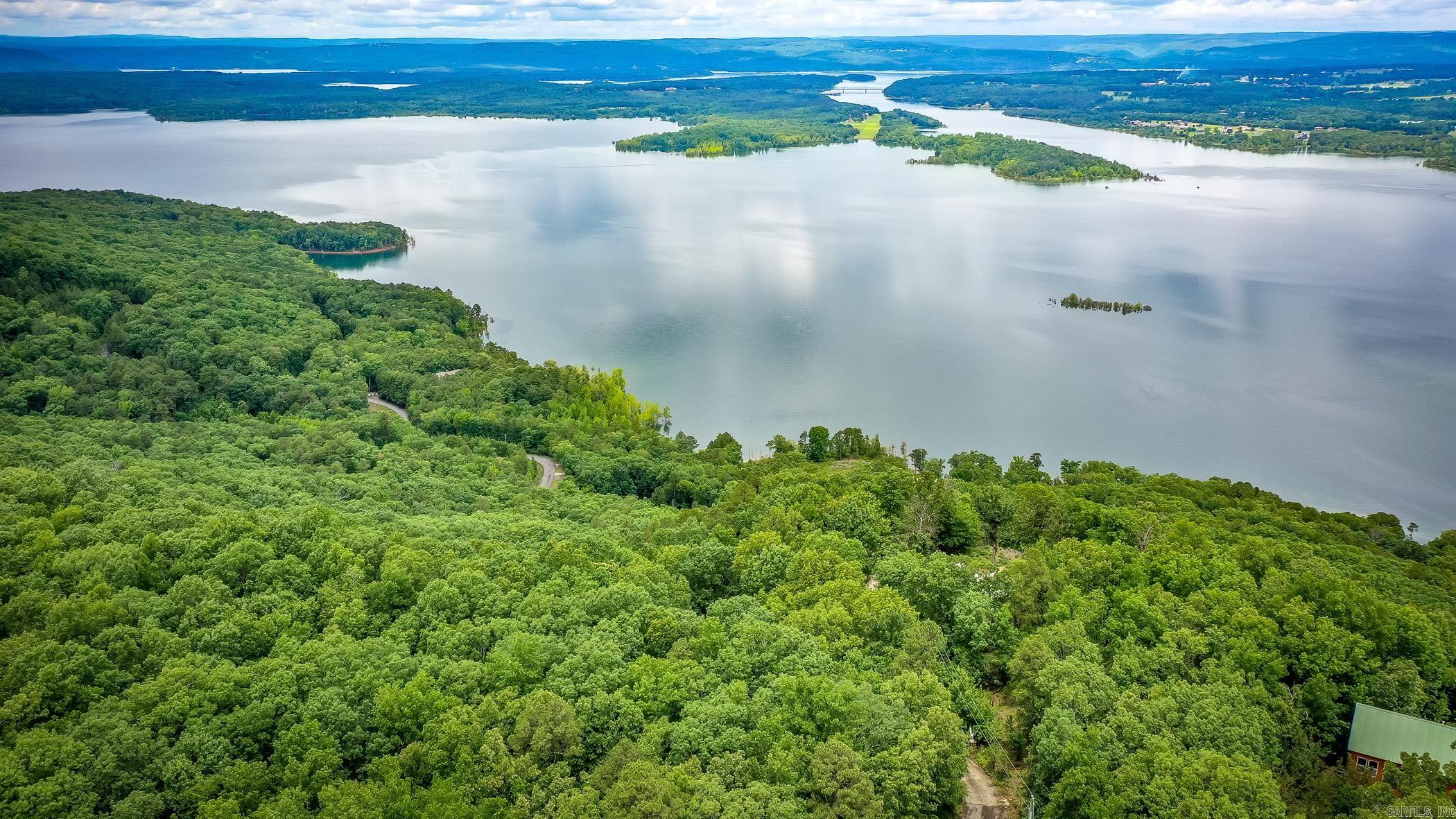 Experience breathtaking, panoramic vistas from this exceptional 5.33-acre lot situated off Diamond Bluff Road. Perched above the shimmering waters, this property boasts commanding views over the expansive lake and down the scenic Narrows—offering sunsets and sunrises that will leave you in awe. The site previously featured a 3,000+ sq ft home, which was recently cleared following a fire, making this the perfect blank canvas for your custom retreat. All the essentials are already in place, including a gated driveway, established landscaping, septic, water, excavation and on-site power—saving you both time and expense as you bring your vision to life. Embrace the tranquil lifestyle with easy access to three nearby marinas, ensuring endless opportunities for boating, fishing, and lake adventures. Whether you’re seeking a serene escape or an entertainer’s paradise, this rare offering is ready for you to build the luxury home of your dreams. Don't miss out on this incredible opportunity—your slice of paradise awaits! See Attached Documents