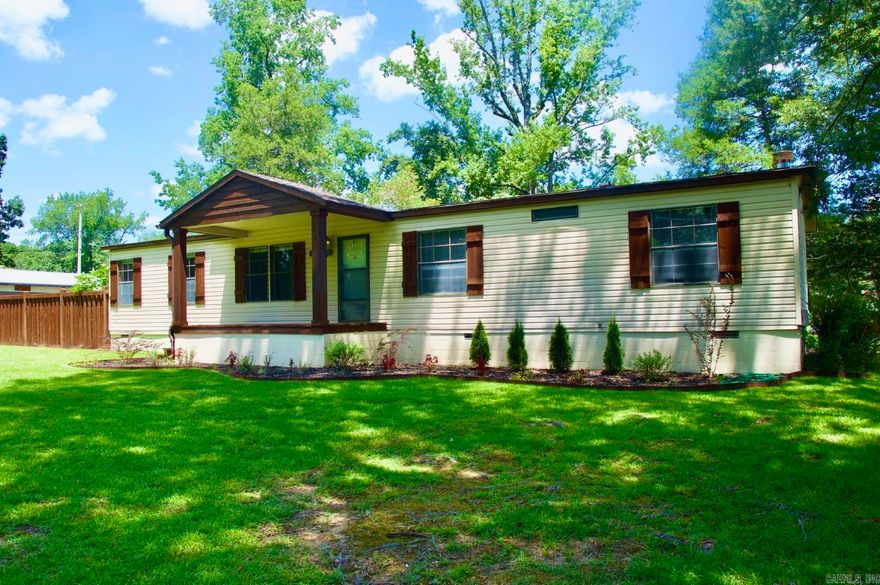 Lakefront property with 150ft of shoreline on Lake Hamilton with deep water near the main channel! Situated on .57 acres outside city limits and not subject to HOA restrictions. Enjoy lake life with a boardwalk over the water, a patio for lounging, and outbuildings for storage or hobbies. The back porch, with its vast windows, is perfect for relaxing and entertaining. The house features several updates, including new fixtures and custom cabinets. This is your opportunity for prime waterfrontage on a budget!