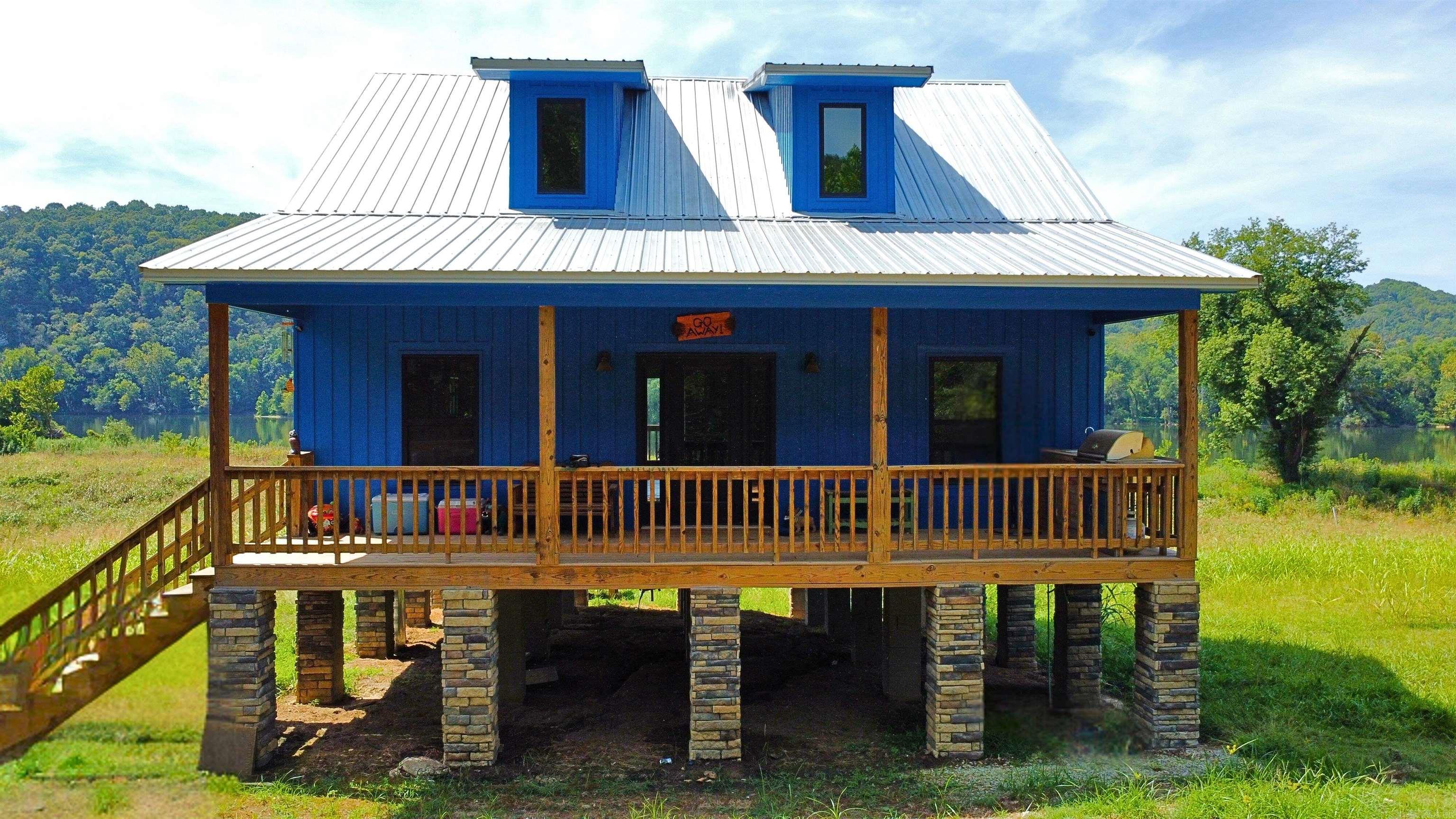 White Rivers finest cabin! This cabin is one of a kind rare find setting on 2.5 acres outside of Guion. Built in 2022 this cabin was tastefully designed by the current owner. Beautiful quartz counters, vaulted ceiling, 2 full size tiled showers, Massive gas fireplace with a wood burning conversion, Generac generator, fresh tapped well in 2022, metal roof, extra deck below your back patio. The home features central HVAC with mini split options for the upstairs. This home comes fully furnished (all appliances & furniture). With miles of trails to ride & the ability to get to Batesville & Mtn. View with ease makes this secluded paradise not "so far" from town. This property sets on 2 lots. The neighbors to the left have yet to build & the 2 lots to the right are also for sale through another brokerage. Trout, Bass & Walleye are flurishing in the area. Lots of wild game and hunting opportunites around. If this wasnt enough youre blessed with 2 full size bedrooms that each have their own built in electric fireplace. You get the loft area to serve as your 3rd bedroom, game space or office!