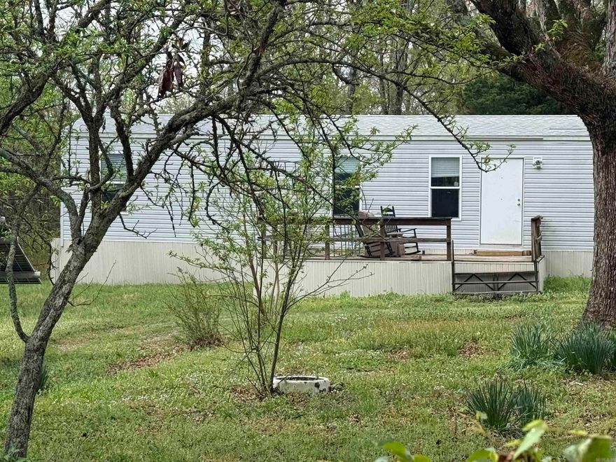 Nice quaint mobile Home on 3 acres in town with city water and sewer lying along Barton Avenue (Polk Road 136).  This property has an older Home that suffered some fire damage but could be rebuilt.  This would be a great starter property or it could be a great opportunity for the savvy investor.  Property has some solar panels but they are not operational.  There is a covered parking area for 2 vehicles.