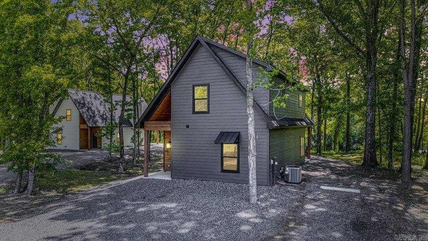 Welcome to The Onyx, a brand-new luxury cottage on the Little Red River, one of Arkansas’s most sought-after trout fishing destinations. Whether you're searching for a private retreat, vacation home, or turnkey short-term rental opportunity, this riverfront property delivers. Thoughtfully designed with custom finishes, the open-concept layout features a cozy fireplace, floating wood shelves, and sleek quartz countertops. The main-level primary suite offers a walk-in closet and spa-style tile shower. Upstairs includes a spacious guest bedroom and bonus loft with a closet, ideal for guests, a bunk room, or added living space. Enjoy the cedar-wrapped front porch with wooded views, then relax on the covered back deck overlooking the river. Just steps away, the brand-new shared covered dock offers easy access for fishing and enjoying the water. Minutes from town and just over an hour from Little Rock.