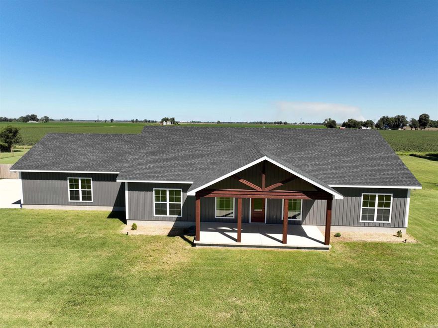 Discover this stunning 2022-built home in the Bay community, offering a perfect blend of modern convenience and rural charm. This 3-bedroom, 2-bath beauty sits on 1.92 acres in the heart of Cotton Country, providing a peaceful retreat just a short drive from shopping, dining, and employment.  Inside, you'll be greeted by elegant concrete floors and a gorgeous stone fireplace with gas logs, perfect for cozy nights. The spacious kitchen is a chef's dream, featuring a large island with a gas cooktop and a double gas wall oven. The thoughtful design and meticulous attention to detail throughout the home reflect the hard work and love the owner and family poured into the property.  Sprayed insulation and a Storm Shelter in the garage. With 4,200 square feet under roof, including 2,325 square feet of heated and cooled living space, there's plenty of room to relax and entertain on the screened in back porch or sit on the covered front porch. The 2-car enclosed garage adds convenience and security.