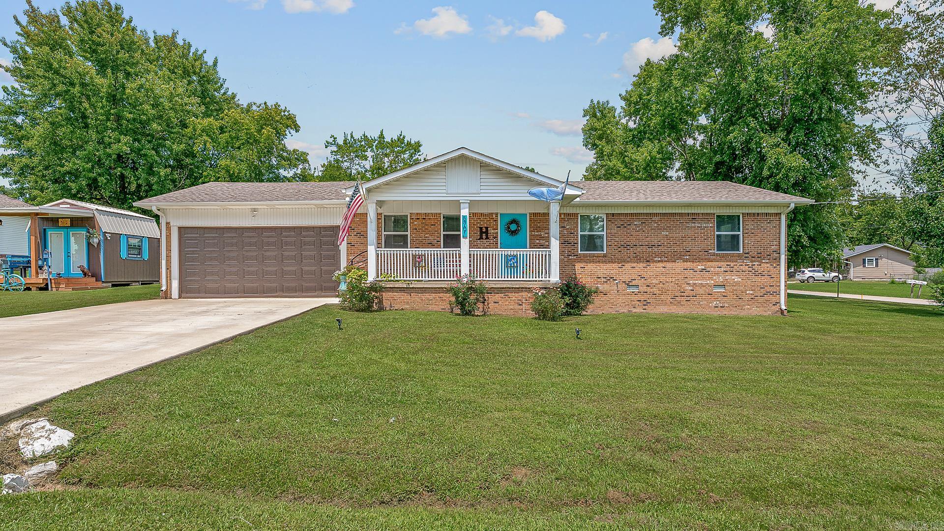 Welcome to 5701 Cedar Street in the Forest Heights Subdivision in Paragould, AR. This well-maintained mostly brick home offers the perfect blend of functionality, comfort, and charm—from the inviting covered front porch to the thoughtfully designed open-concept layout. The spacious kitchen features an island with a breakfast bar and ample cabinetry with oversized drawers for optimal organization. The home includes 3 bedrooms, 2 bathrooms and a convenient laundry area located just off the garage entrance. Step through the French doors off the dining area onto the deck within the fenced backyard—ideal for relaxing or outdoor entertaining. An added bonus is the exterior storage building, complete with a covered front porch, electricity and a portable air conditioner—perfect for hobbies, a workshop or additional storage space. This move-in-ready home could be yours. Call today to schedule your private tour!