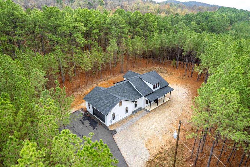 Charming 3-bed, 2-bath farmhouse built in 2024, nestled on 4 acres in a newly developed area in Fountain Lake School District just a few miles from Hot Springs National Park. Features include 9 foot ceilings throughout, LVP flooring, stunning granite countertops, large master suite with walk-in closet, and an oversized 2-car garage. Pulling up the driveway you'll notice peace and privacy and a welcoming front porch. Don't miss out on this exceptional opportunity-schedule a viewing today!