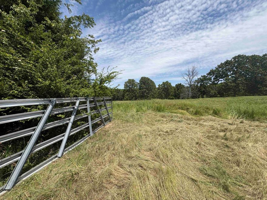 (Tract 2) This beautiful 8.75-acre property offers a perfect blend of privacy, usability, and outdoor recreation. The land features cleared and seeded pasture areas fenced on two sides, ideal for livestock, gardening, or future improvements. A scenic wet-weather creek winds through the property, while buried utility lines help preserve the natural beauty and scenic views. Water lines have already been extended to the pasture for a future barn or garden setup. Located just minutes from Rim Shoals access on the White River, this property offers peaceful country living with convenient access to world-class fishing and river recreation. This property can also be purchased with an additional 8+ acres with a shop/home complete with kitchen and bathroom. See MLS#26018146 and #26004607.