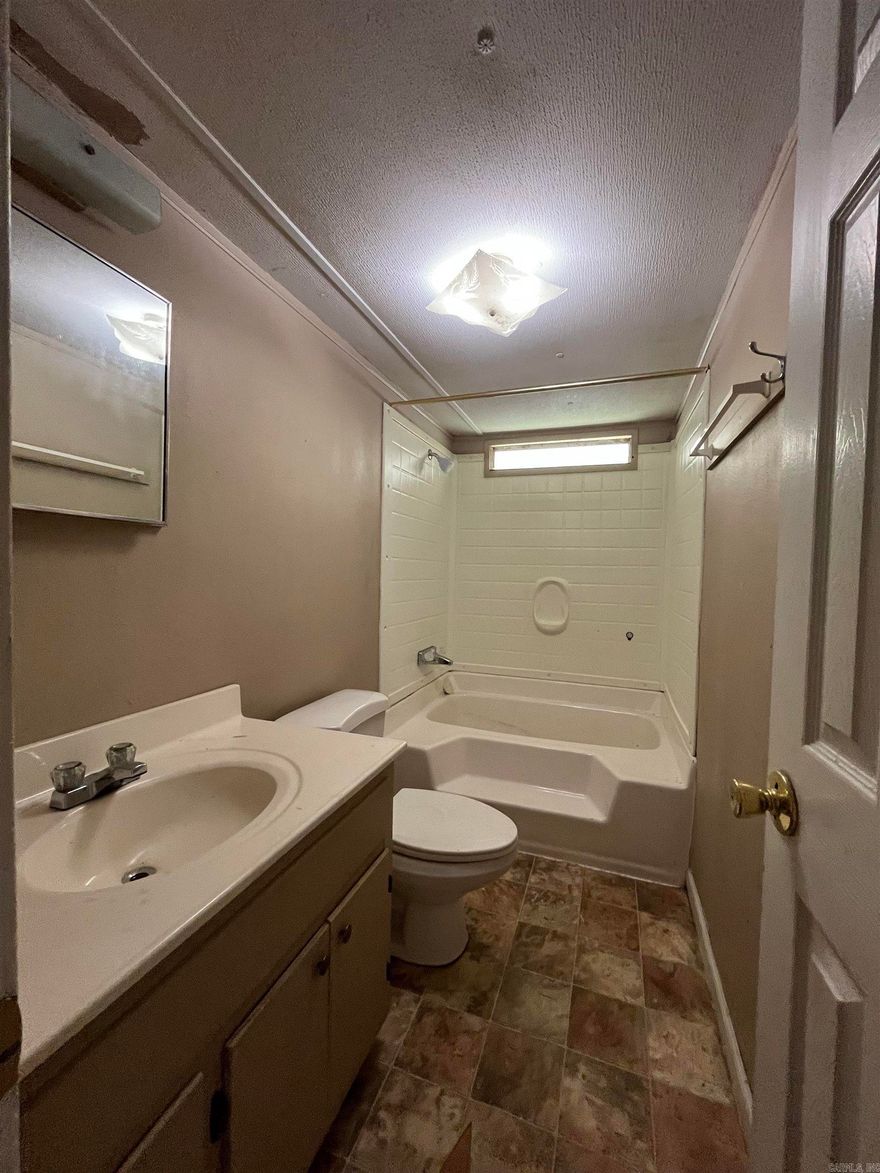 Fixer upper on 3 lots and a nice shop. Property is fenced in with a big front  covered porch.