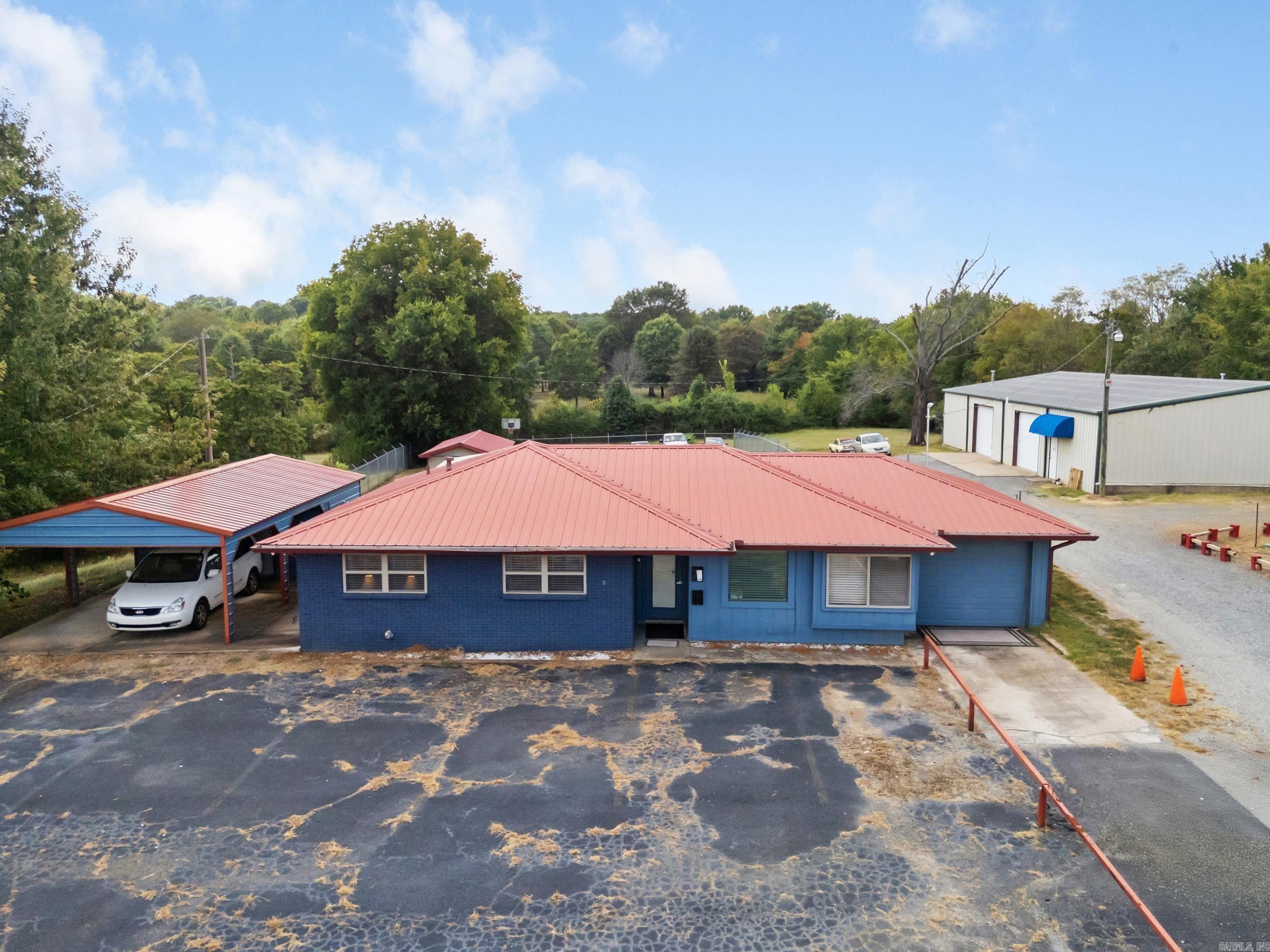Prime location for commercial property opportunity w/ Hwy 65 frontage that could also be residential if desired! 1,172 sq ft home has 3 bedrooms, 2 bathrooms, fully equipped kitchen, garage, carport and storage building. Front is paved and surrounded by steel fencing, large back area has 2nd large storage building & enclosed by chain-link fencing. Hot water heater-1 yr old, Metal roof & Septic tank-6 yrs old. So many possibilities with this property!!