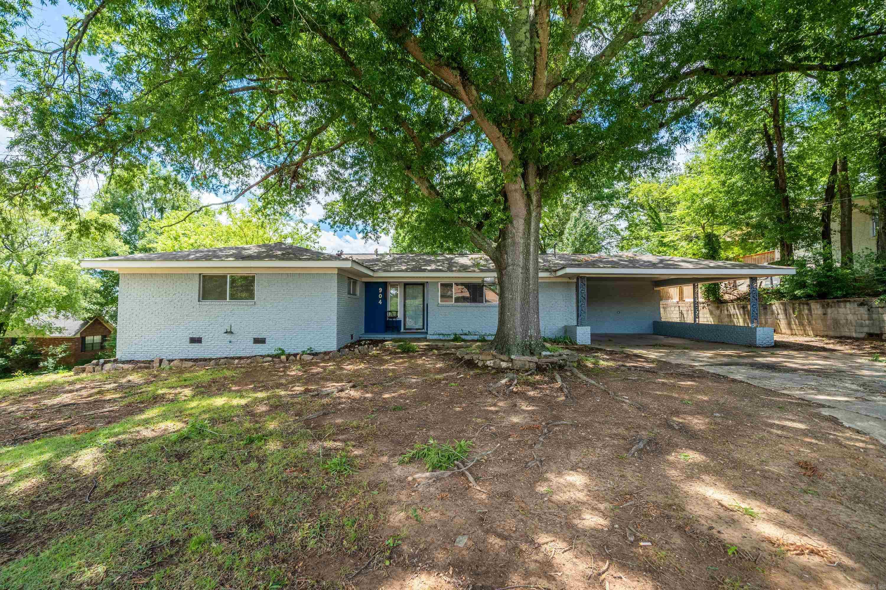 Located in the heart of Hot Springs, this turn-key brick beauty is set on a spacious corner lot, under the shade of a majestic Willow Oak. The 3-bedroom, 2-bath, one-level home comes fully furnished and is operating as an income-producing short-term-rental. You'll appreciate the fully fenced back yard, the heated/cooled sun room, the cozy gas fireplace, and the original hardwood floors in the living area/bedrooms. The low maintenance exterior, newer outside H/VAC unit, and a newer roof offers peace of mind for years to come. Located just one mile from Oaklawn race track, you'll love the convenience and close proximity to Hot Springs' amenities. Whether you're looking for a wonderful city home or a savvy investment property, this home offers loads of potential. See MLS #: 24026133 for the complete investment package which includes 3 short-term-rental properties.