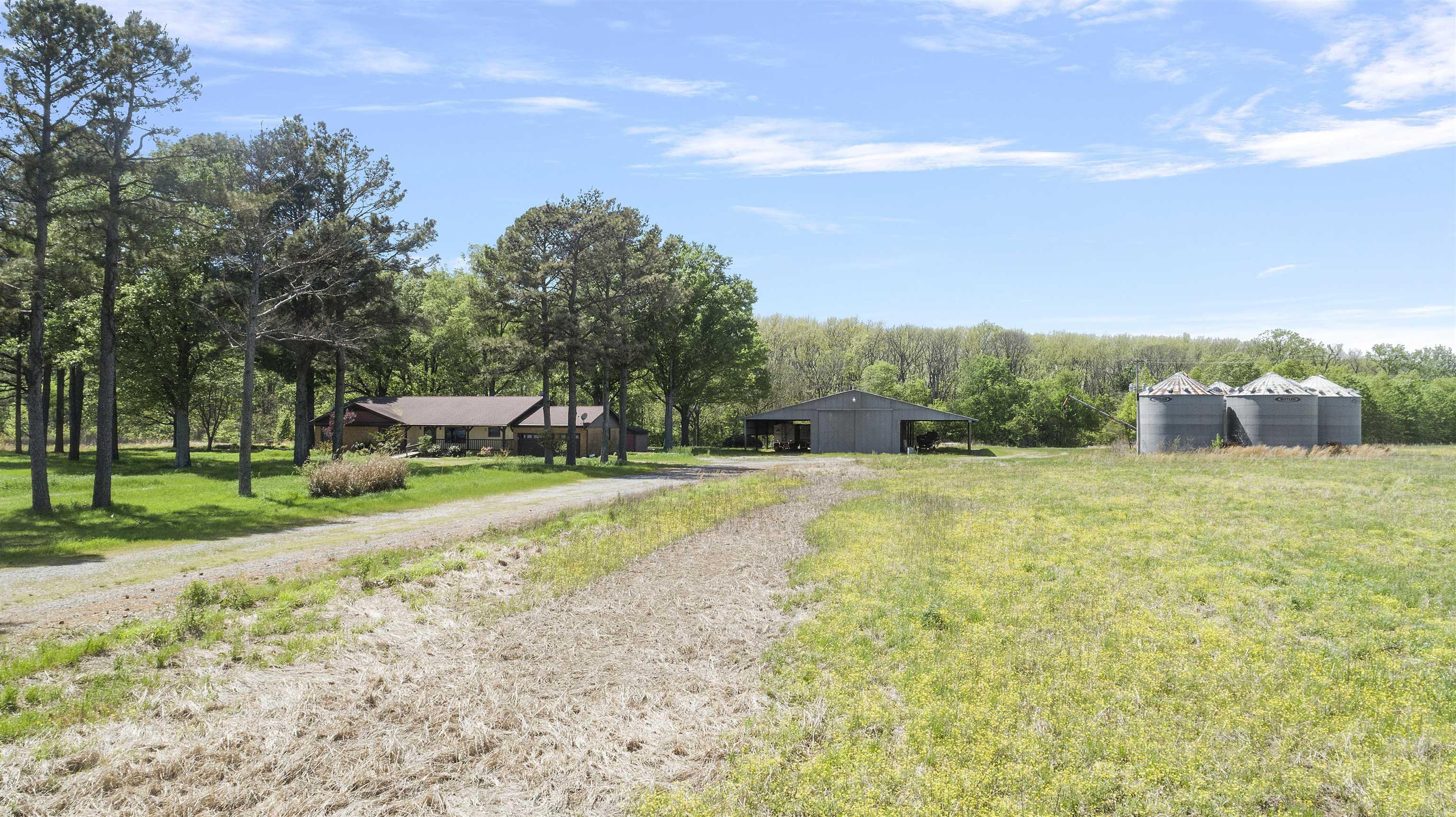 This beautiful 25-acre property features a well maintained, one owner home offering 4 bedrooms and 3.5 bathrooms. Perfectly situated in a peaceful rural setting, this property is ideal for those seeking space, privacy, and functionality. This home is complemented by an extra large shop with outdoor coverage providing ample space to park semi trailers, tractors, and a full range of farming equipment. Additionally the property includes 5 grain bins making it a great opportunity for those involved in agriculture and looking to own a piece of country side with excellent infrastructure already in place. If you enjoy the outdoors, this property is a dream come true with great opportunities for duck and deer hunting right out of your back door. Call today to book your showing!