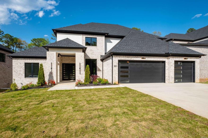 Experience the perfect blend of luxury, traditional charm, and modern design at 221 Abington Court, nestled in the highly sought-after Chenal Valley neighborhood. This stunning home boasts soaring ceilings, indirect lighting, designer-selected colors and fixtures, and a chef’s dream gourmet kitchen. The main level offers two spacious en suite bedrooms and a dedicated office, while the upper level features two additional en suite bedrooms and a fully equipped media room—ideal for family and guests alike. Step outside into an entertainer’s dream with a covered patio, outdoor fireplace, full outdoor kitchen, and a additional deck, all surrounded by peaceful green space for added privacy. An oversized 3-car garage completes this exceptional property. Don’t miss your opportunity to make this stunning home yours! Some photos have been redone by AI Generator.
