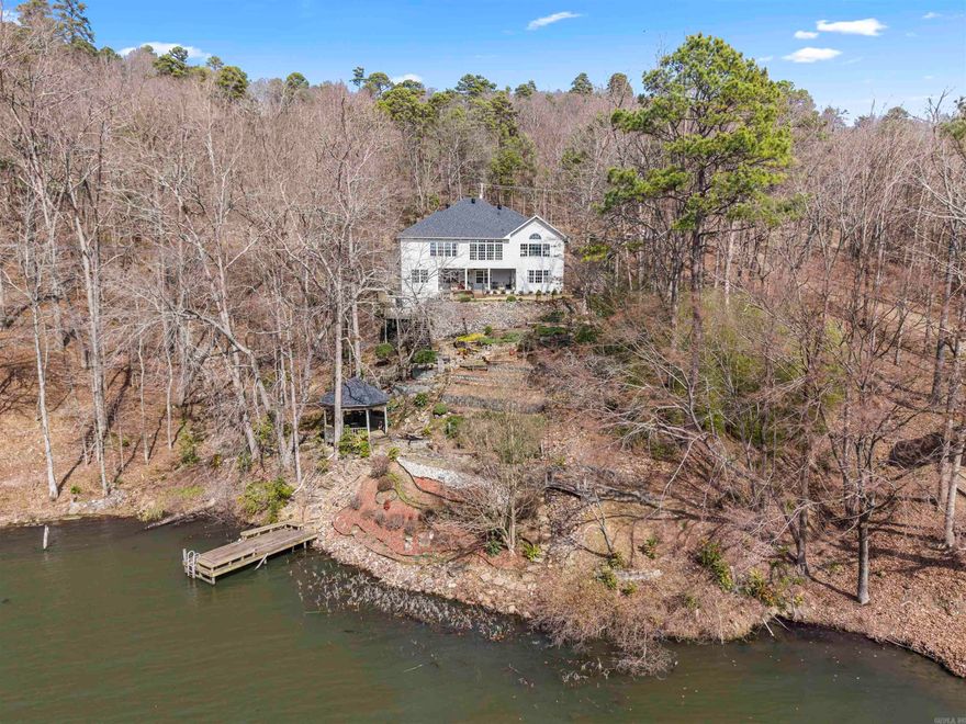 PANORAMIC Views over Lake DeSoto from this One-Owner Lakefront Custom Home! 4 Bedrooms/3.5 Baths - Over 3100 sq ft with a NEW ROOF! Upstairs boasts a Den/4th Bed off the High Ceiling Entry with Guest Bath access, and the Primary Suite with Lake View, and Ensuite with His & Her Walk-in Closets, Dual Vanity & Jetted Tub! A Formal Dining Room can seat more than a dozen people easily! The Sun Room and Living Room both take advantage of the Gorgeous View over the Lake! The Granite Island Kitchen with Walk-In Pantry offers a Down-Draft Range and flows to the Eating Area and Living Room with Cathedral Ceiling, Built-ins and Gas Fireplace! Conveniently access the 2 Car Garage through the Laundry Room with Wash Basin. Downstairs you will find a Large Living Area, Storage/Utility Room, 2 Bedrooms, and Jack & Jill Bathroom. The Walkout to the Patio is stunning overlooking the Terraces, Deck, Gazebo and Dock! Lake DeSoto is a 200 Acre, Full Recreation Lake (Water Ski ok) and the 4th largest in the Village! The Owner is a Master Gardener and has lovingly provided terraces and irrigation for gorgeous plantings to reveal themselves in the Spring!