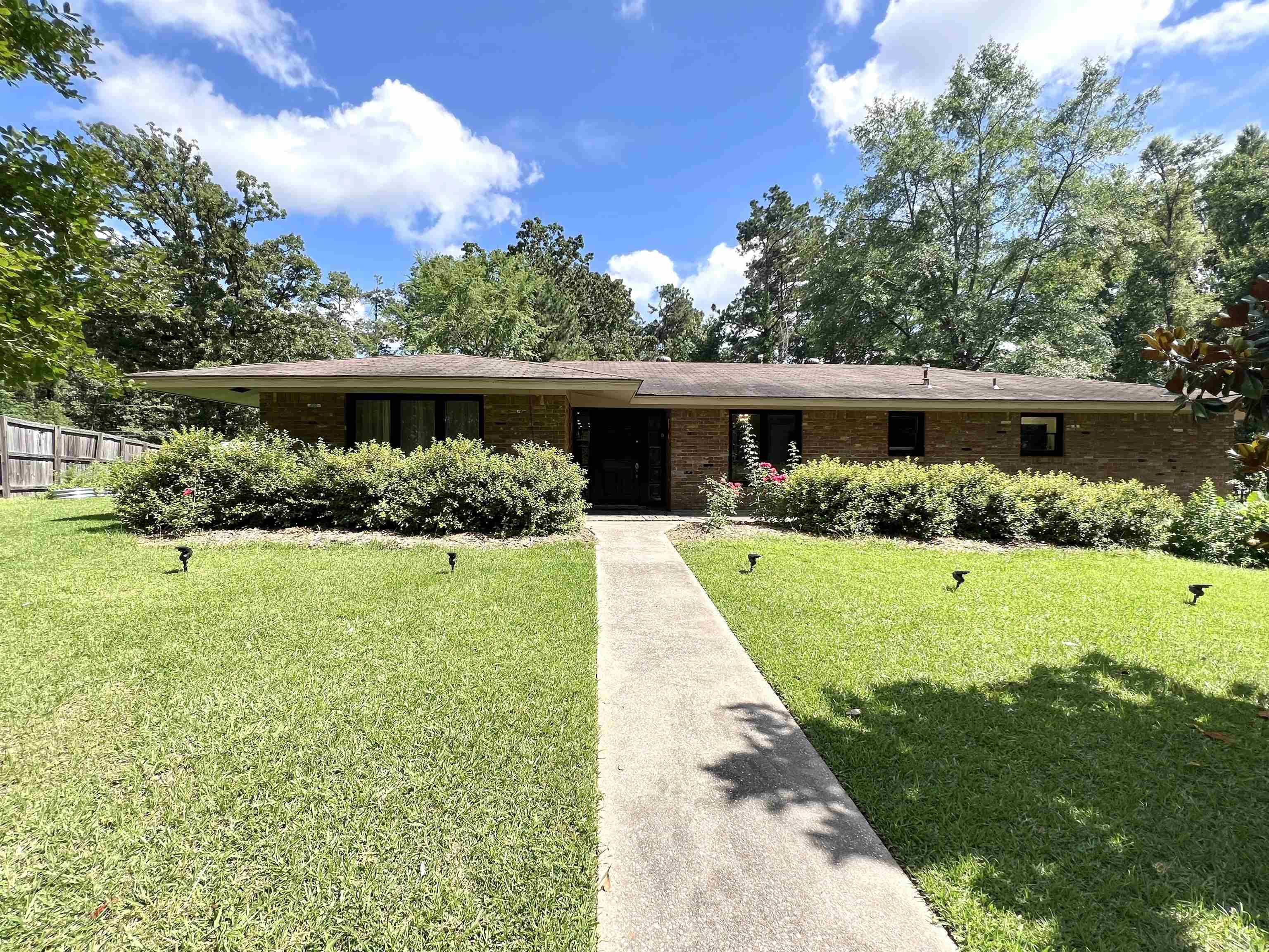 Perfectly positioned in a well-established neighborhood, this spacious four-bedroom traditional home offers room to spread out and make it your own. With two options for a primary bedroom, you'll have the flexibility to choose the space that fits your lifestyle-whether that's a quiet retreat or something closer to the heart of the home. Each bedroom features oversized closets that can handle your wardrobe and then some. Home also includes a formal dining room and two living rooms!! The home is flooded with natural light, giving a warm and inviting atmosphere throughout your day. The kitchen comes fully equipped, and yes, that includes stove/oven, dishwasher, microwave-no need to stress about appliance shopping. You'll also enjoy the convenience of nearby community amenities including the park, grocery stores, churches, public swimming pool, hospital, local University and shopping! Set on approximately 1.28 acres spread across three lots, the generous outdoor space means there's plenty of room to relax, entertain, or expand. Whether it's planting a garden, building a play area, or simply enjoying the fresh air, the possibilities are endless.