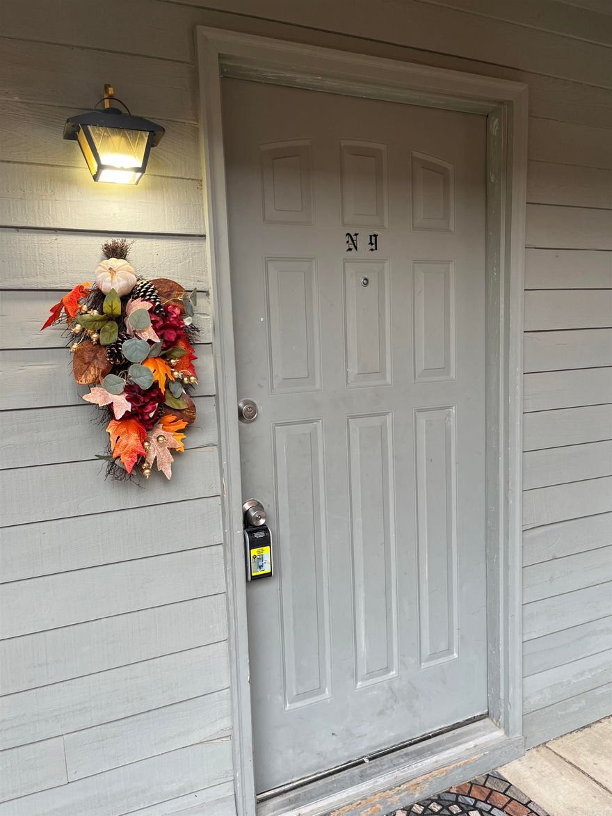 Updated 2BR/1.5BA Cambridge Court condo with complex in ground pool. Features include open living area with fireplace, wood-look flooring, and private balcony. Kitchen offers updated cabinets, backsplash, and pass-through to living room. Bedrooms are spacious with good closet space; primary bath includes large soaking tub. Neutral paint and modern finishes throughout. Convenient location near shopping and dining.