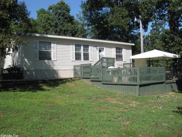 2007 DOUBLE WIDE W/EXTRA LOT W/A VIEW. 3 bedroom 2 bath with laminate flooring, double deck off front, storage room that can be used as a storm shelter on the extra lot. Master bedroom has walk-in closet with master bathroom on one end and the other two bedrooms and bath are on the opposite end for privacy. The view out the back off the deck is a must see! Quiet neighborhood.