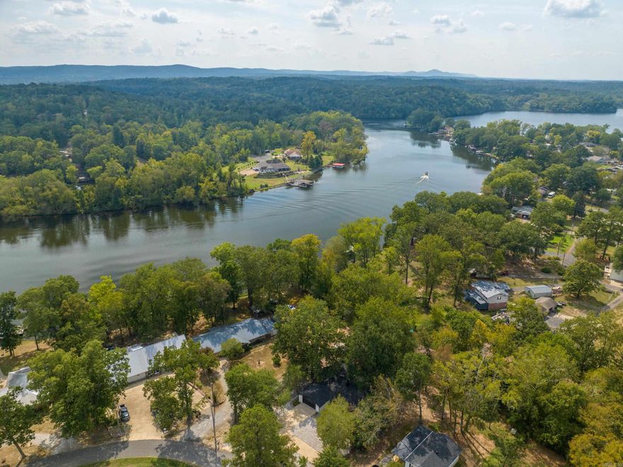 *Lakefront home with covered boat dock!*   This beautifully updated home offers lakefront living at its finest, featuring an open concept layout, a covered boat dock, and modern upgrades, including a new roof, HVAC, and state of the art appliances. The neighborhood includes a private boat ramp, adding even more convenience. Enjoy outdoor living with a spacious deck, patio, and a 19x9 storage building, perfect for storing lake toys, kayaks, or outdoor gear. Conveniently located 5 minutes from the MLK bypass, 6 minutes from Lakeside schools, and 10 minutes from Bathouse Row, this property is close to shopping and dining. Currently a short term rental, it's available fully furnished with high end contents. *Entergy approved permit do dredge the lake 2 feet.*  Call today to see this turnkey lakefront retreat!