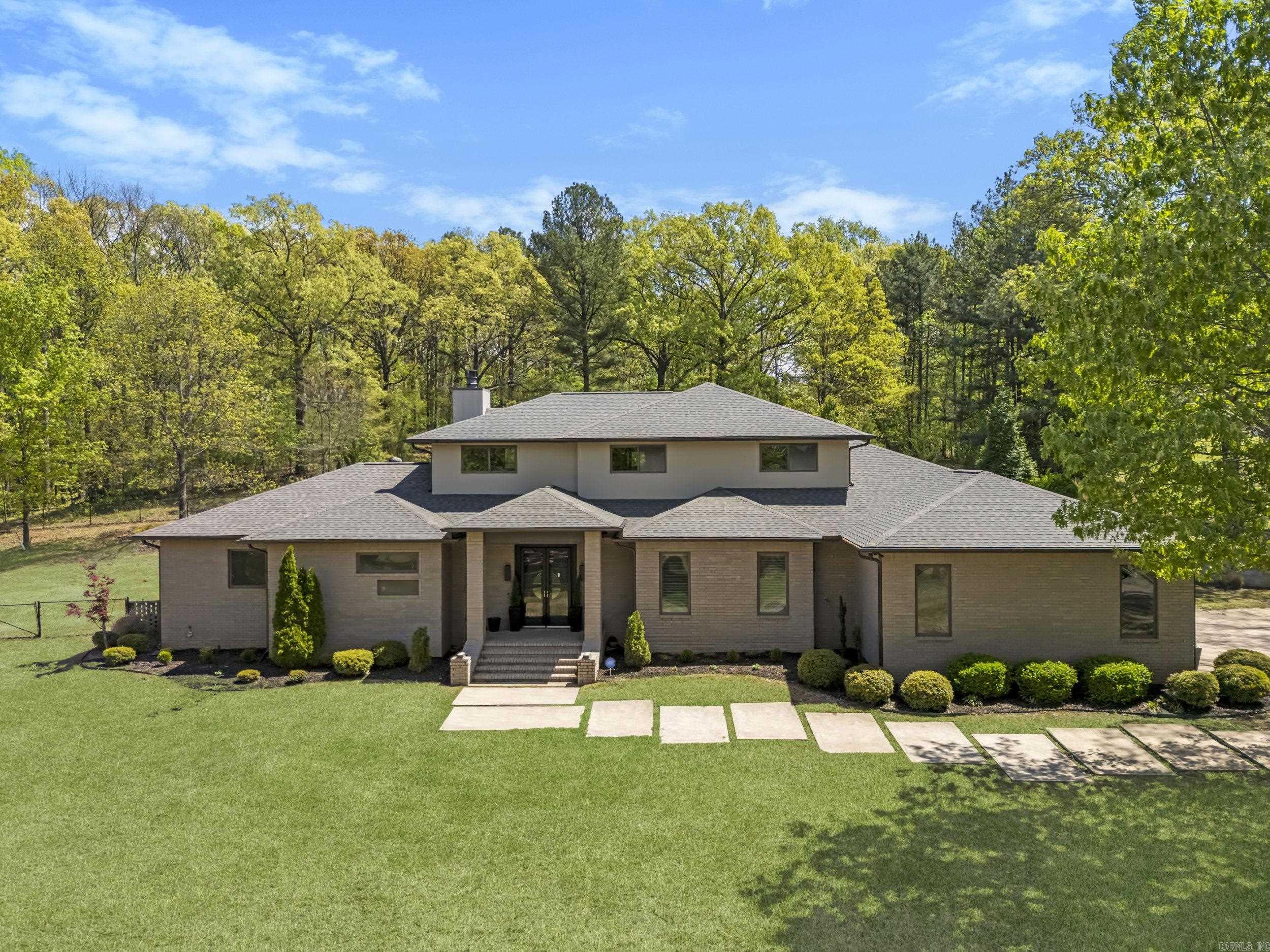 An Architectural Masterpiece on Crowleyās Ridge Wynne, Arkansas | 5,020 Sq Ft | 4ā5 Bedrooms | 4.5 Baths | Private Pool Retreat Welcome to a home of rare distinction, gracefully perched atop Crowleyās Ridge. Upon entry, one is greeted by a grand room anchored by a striking wood-burning fireplace, elegantly clad and framed by custom-built cabinetry. Seamlessly flowing into the heart of the home, the designer kitchen is a culinary dreamāshowcasing dual islands, handcrafted cabinetry, custom concrete countertops, a 6-burner range, double ovens, built-in microwave, and a walk-in pantry. Ideal for both intimate and large-scale entertaining, the home also features a light-filled breakfast or keeping room, along with a formal dining space enhanced by an art niche. The primary suite is a sanctuary unto itself, complete with a serene private office and a lavish en-suite bath. Three additional bedrooms grace the main level, including a full guest suite with private bath and a thoughtfully designed Jack-and-Jill configuration. A chic powder room and laundry as well. Head upstairs to discover a spacious family or game room, a full bath, bedroom/office. Outside a resort style pool awaits!