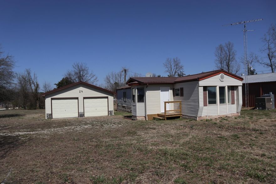 MOBILE HOME WITH SHOP BUILDING AND LOT FOR SALE ASH FLAT AR  Property is located at 12942 Hwy 62/412 E, Ash Flat, AR. 1986 mobile home with approx. 952 sq. ft. of living area with 2 bedrooms and 1 bath. It has Central Heat and Air. There is not a title to the mobile home that is available. It also has a 2 bay shop building with concrete floor and electric. It has approx. 1/2 acre lot with highway frontage. It has rural water and septic system. Plenty of space for your garden.