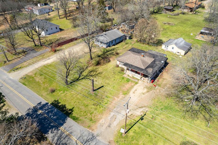 THIS LISTING INCLUDES ADJOINING LOT AND HOUSE AT 130 SOUTH PEPRSIMMON & 2737 SPRING STREET with a total of 3.03 acres.  This property is next to Cutter Morning Star and is visual from the bypass.  It's in the county and can be used for residential or commercial. The home on Persimmon is the larger of the two homes and the blue house is on Spring Street.