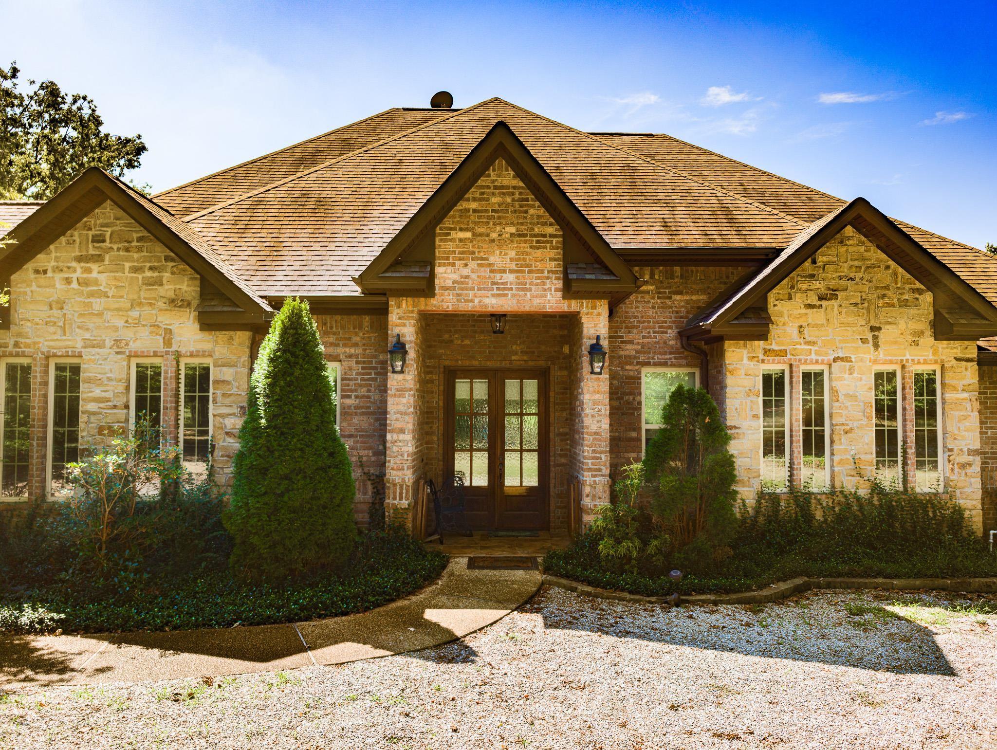 Stony Springs Farm, a breathtaking 20-acre MOL haven nestled in Jessieville School District! This stunning 3600 sqft home, custom-built by Carriage Homes, features an array of exceptional details & amenities. Discover the perfect blend of comfort & luxury with 3 spacious bedrooms, 3.5 elegant bathrooms, a dedicated office, & a beautifully appointed dining room. The heart of the home features custom cabinetry, ample counter space, a gas range, double oven, & a convenient wet bar with ice maker. The expansive primary suite is a serene retreat, complete with a spacious bathroom, tub, walk-in shower, & a generous walk-in closet/dressing room with custom built-ins. Two generously sized guest rooms each boast their own large bathrooms. The outdoor oasis is perfect for relaxation & entertainment, featuring a unique covered patio with ample seating, grilling area, screened area & a stunning water feature. Additional highlights include an oversized 3-car garage with an easily accessed attic storage, a charming 1-bedroom cottage, a large horse barn with corral & stalls, tack room, greenhouse, spacious red livestock barn, weaning pasture, two ponds & serene creeks, brand 40X50 shop, and MORE!
