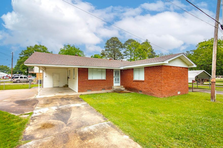 The home is perfect as a place to downsize or start off.  It is neat and clean.  Living room, kitchen, 3 beds, 2 baths with laundry.  A fenced yard and carport are attached.         New floor treatments and bathroom showers and fixtures just completed on 4/1/2026.  A combination package with the house next door 1003 is priced at $199,999.