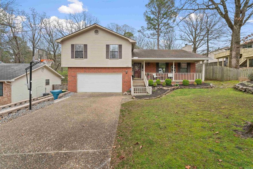 Welcome to your ideal family haven boasting 4 bedrooms and dual living areas, nestled within the coveted Roberts and Pinnacle View Middle school district. This charming abode features a spacious backyard, complete with a delightful playhouse for the little ones and a serene covered deck where adults can unwind.  Step inside to discover a versatile split-level layout, offering privacy with one bedroom tucked away for guests, kids, or a home office. The kitchen, equipped with a convenient gas cooktop, seamlessly integrates with the airy great room with ample windows, creating a bright and inviting atmosphere for family gatherings or movie nights.  A separate front family room, enhanced with built-in bookshelves, provides additional flexibility for relaxation or entertainment. Indulge in the luxuries of the primary bathroom boasting recently renovated tile flooring and a pristine shower. Convenience is key with easy access to the LR Athletic Club, Starbucks, an array of dining options, shopping destinations, and the nearby I-430. While the yard may feature a gentle slope, the flat driveway offers ample space for basketball enthusiasts, complemented by an extra parking pad on the side.