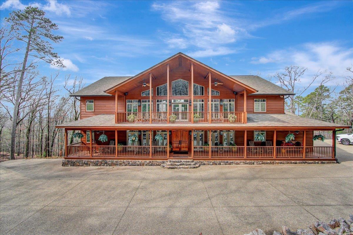 Luxury Lake Ouachita rivaling lodges in Lake Tahoe or Colorado. 9600SF under roof, 8007SF of heated & cooled space, with Lake Ouachita views. Built on 3 levels with expert craftsmanship & immaculate detail. 4 professionally designed luxury themed suites all including jacuzzi tub, walk in stone shower, double vanity sinks & heated flooring. Upper-level open bar area. Lower-level game room & heated & cooled garage. Smart Home. Full generator backup. Open & screened porches. Pella windows. Lutron lighting. Extensive exterior areas for entertaining. Exceptional attention to detail. Exterior of the home has been recently completely sealed and stained. All furniture, two See Doo's with slip and lift are negotiable.