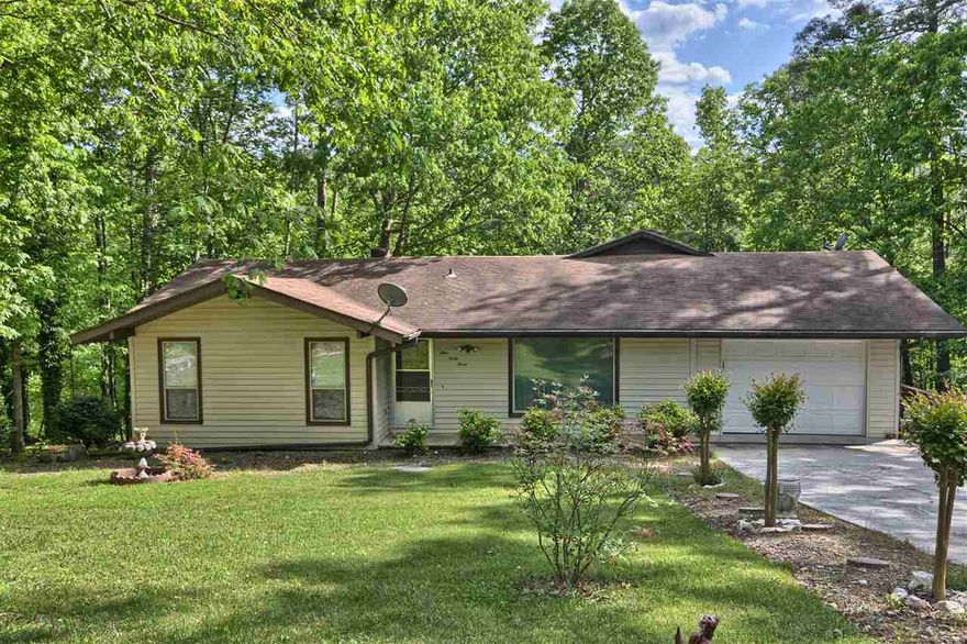 Updated home with 2 bedrms and 2 baths. New Roof with Full Price Offer. Check that off your list. Now come see this bright Living Room with vaulted and beamed ceiling and large picture window, open to large Kitchen with mobile island and Pantry area at one end and dining area at the other.  Open to the Arkansas Rm with lots of windows overlooking the yard, with Bonus Rm with standalone heat and air unit. Walk around the side of the house, under the AR Room is Workshop 13' X 10' and covered patio.