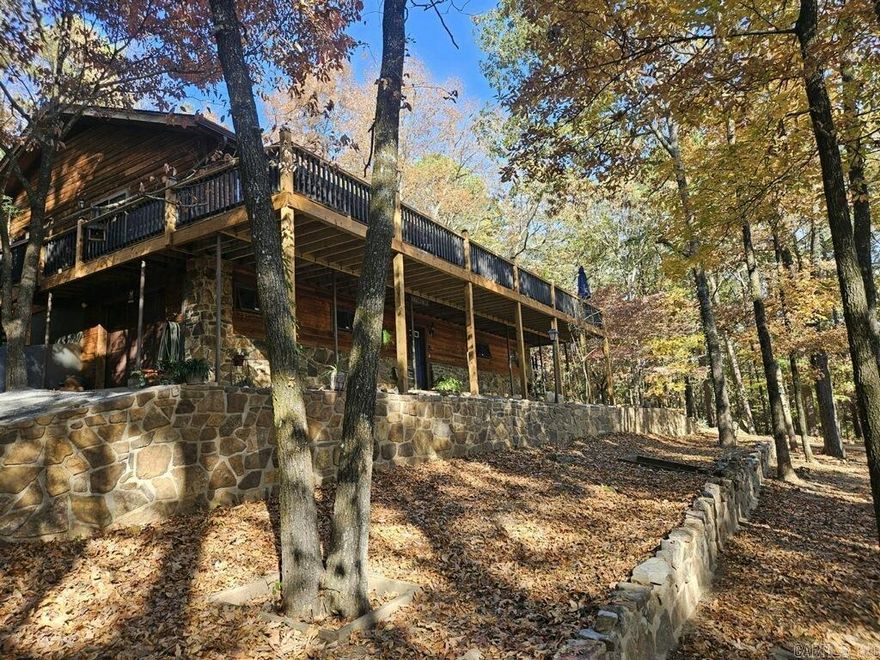 "Eagles Nest" a place to relax & enjoy lofty views from the privacy of the expansive 60' x 12' deck.  A custom cedar and stone home; a nature lovers retreat surrounded by mature trees.  Two huge primary ensuites with separate showers & jutted tub.  Spacious island kitchen, custom oak cabinetry, built-in pull-out drawers built-in corner lazy-susans, double door swing-out spice cabinet. Stainless steel appliances. Fresh interior paint, new wood laminate flooring, new roof.  Lower level offers two car drive through garage, half bath, and two large flex spaces you choose game room, mancave, extra bedroom plus lots of storage.  Enjoy peaceful seclusion at the end of a cul-de-sac in a resort community featuring a golf course, UTV/Bike and hiking trails, Lake and Marina. Not just a home but a lifestyle!!