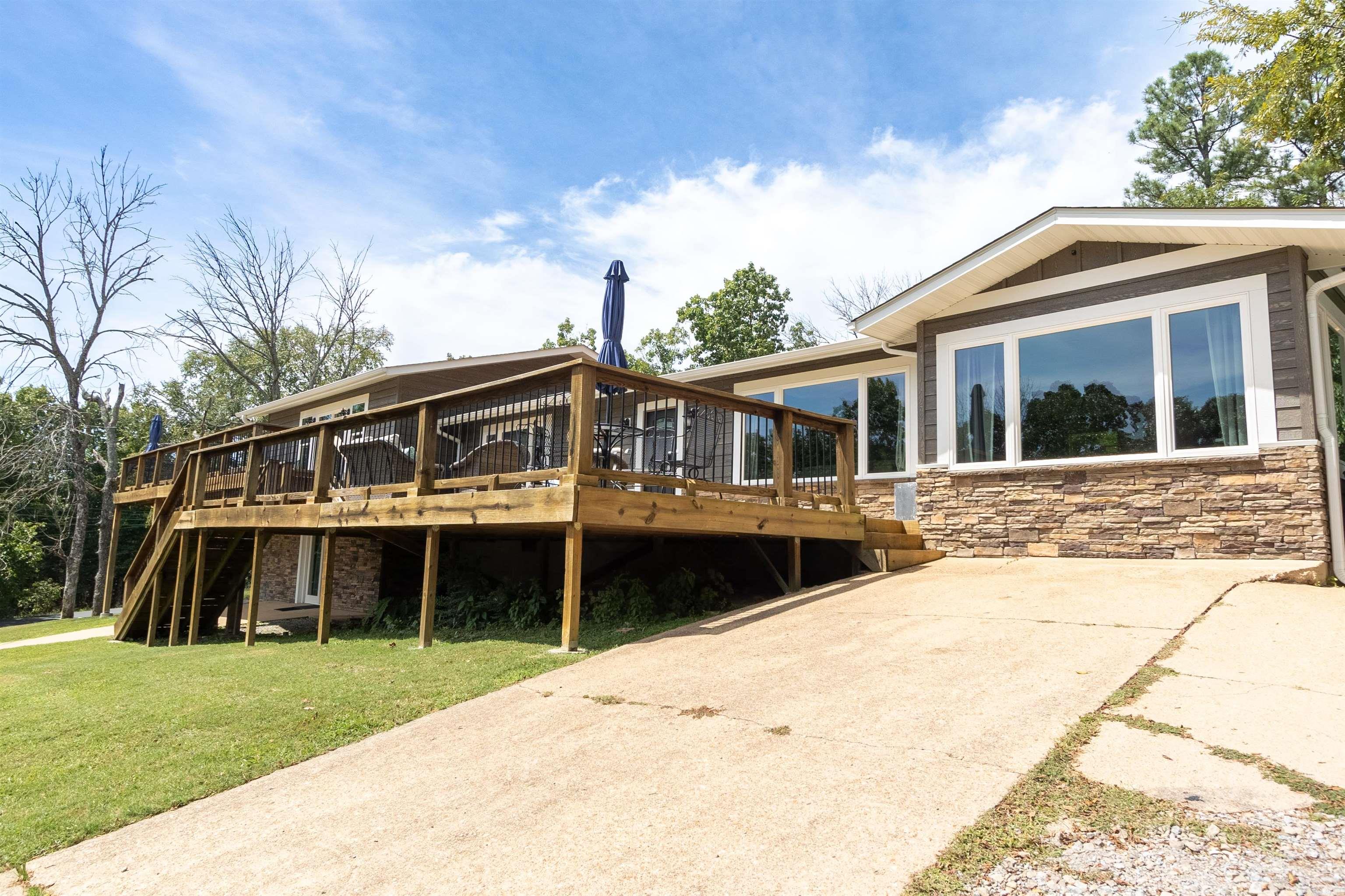 This exquisite Lake House, situated on the picturesque Lake Norfork, is entirely new and meticulously crafted for luxury, comfort, and unforgettable moments. It boasts premium enhancements, including two master suites with en-suite bathrooms, plus two junior suites and a game/bunk room. The property also offers a saltwater pool equipped with a durable electric cover and an 8-person hot tub. The kitchen is outfitted with brand-new appliances and a separate pantry for additional storage. The open-concept dining and living area seamlessly connects to an expansive 2000 sq. ft. deck, accessible from both master suites, the kitchen, the living area, and the downstairs game room. Fully furnished and ready for VRBO rental, this property is listed at $675,000 1.5 ac m/l.