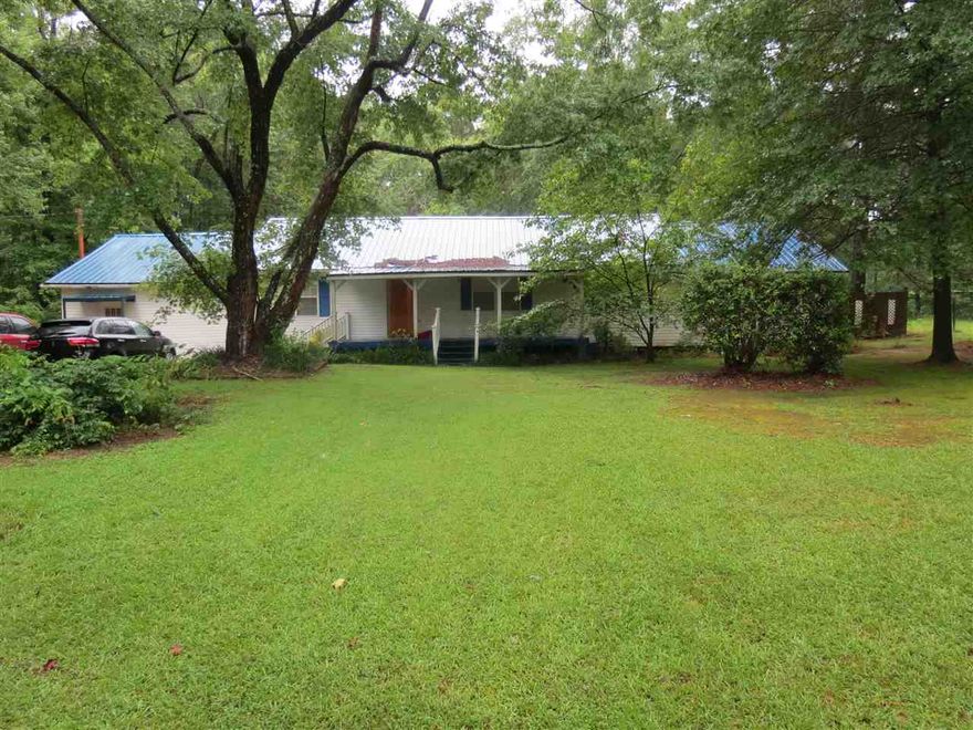 Sit on the front porch and enjoy country living This 3 bedroom, 2 bath home is located on a dead end road in the Sulphur Springs area.  There is also a back porch and a sun room to enjoy.  Metal roof.  Shop with roll up door, and 2 smaller storage buildings.  Living area, large dining area, eat in kitchen for family to gather.  Kitchen has great wood cabinets.  Washer and dryer.  Call me today to see how to get financing with no down payment and no closing costs.