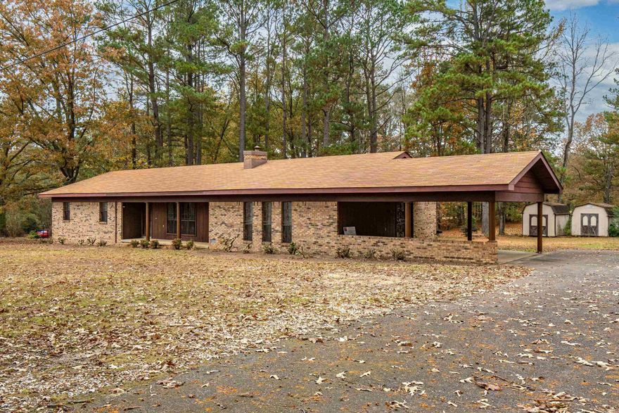 Welcome to this well built 3 bedroom home, 2.5 bath home on 1 acre off Ridge Road outside the city limits but close to everything. This spacious property features both a formal living room (or could be a dinning room or office) and a large den with fireplace offering plenty of room to entertain and spread out. Enjoy relaxing by the fireplace or sitting on the front porch or large back deck overlooking the peaceful surroundings. The roof was replaced 4 years ago and new flooring was just laid throughout the home so it is ready for you! The double carport provides convenient covered parking too! This home is ready for its next owners. There is also an additional 8.97 acres available too listed. Agents please see notes for more information.