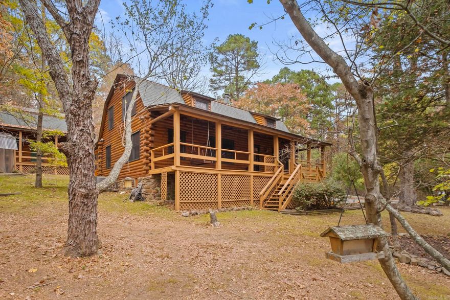 Looking for the perfect log cabin!!??  This home is absolutely stunning!  It has been well maintained by the current owners for the last 40 years!  The pine logs create such a warm and cozy vibe!  The kitchen and dining area are open and on the main floor.  There is also a bedroom, full bathroom and den complete with a Vermont Casting Stove.  The stove can heat the whole house!  Upstairs hosts three bedrooms, a full bathroom and a laundry room.  You will never want to leave the front porch swing!  Watching the wildlife, listening to the birds and leaves rustle are a perfect way to relax.  On the back porch is a lovely hot tub by Hot Spring.  It sits in the corner of a spacious screened in area.  There is a greenhouse in-between the detached garage and log home.  The two car garage is also made of pine logs.  It has 605 s/f on the main level and 365 s/f on the second level.  So much incredible storage!!  As if one porch swing wasn't enough...there is also one on the side porch of this detached garage.  Nestled by Pinnacle Mtn. and on about an acre....this place is so peaceful and beautiful! See Agent Remarks.