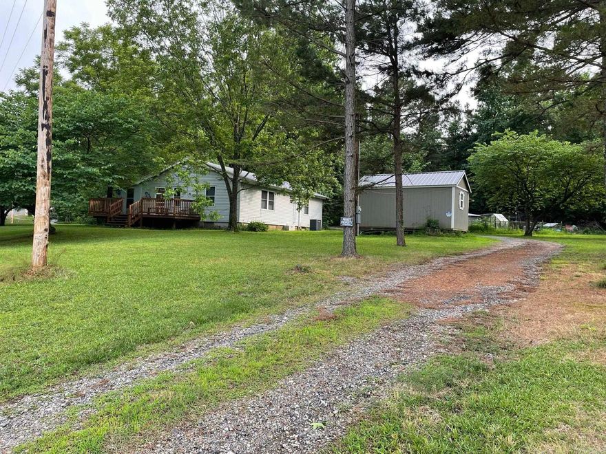 Charming 2–4 Bedroom Home with Bonus Tiny House on 2± Acres Near National Forest & Wolf Pen Gap Trails  Discover this one-of-a-kind property nestled on approximately 2 acres, perfectly located near the National Forest and the renowned Wolf Pen Gap trails. The main home offers 2–4 bedrooms and 1 bathroom, complemented by a generous basement featuring an additional bedroom, laundry area, and abundant storage space.  An attached bonus area serves as a canning kitchen or flower nursery (your choice!), while the spacious garage/workshop provides ample room for hobbies or storage.  Outdoor highlights include a chicken coop, multiple storage buildings, and plenty of open space to enjoy country living. With so many unique features, this property is a rare opportunity you won’t want to miss.  Schedule your private showing today to experience all it has to offer!  The Tiny Home on the Land does not convey