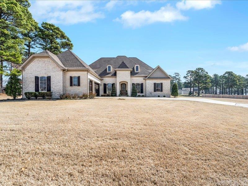 Nestled on 1.57 ac of beautiful views, this home is the perfect blend of luxury and functionality. Featuring 5 generous bedrooms, including a main level master suite with elegant finishes and one of a kind closet connected to laundry, 2 additional bedrooms on main, a home office perfect for remote work or studies, a chef- inspired kitchen with full size side by side refrigerator and freezer, 5 burner gas cooktop and enormous quartz island, and more than enough outdoor space with a large covered porch and level lot, it is a true sanctuary for even the most selective buyer.