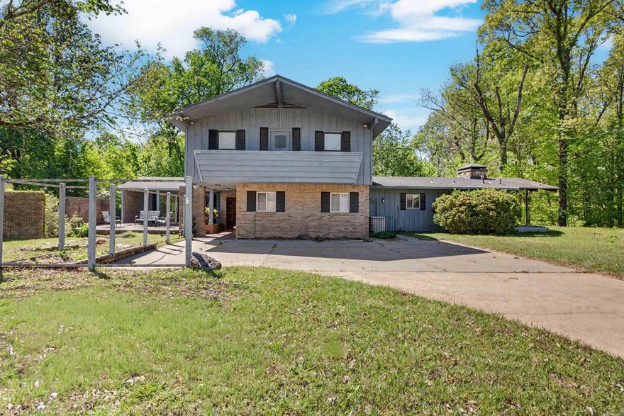 Come and take a look at this stunning home located at 117 Avalon Pl, Helena, AR. Let your eyes feast on this spacious two-story contemporary home and all its splendor built in 1970. This detached single-family property is situated on a large 1.19-acre sloped and level lot at the top of Avalon Place, offering significant outdoor space and a private feel. The home features approximately 3,238 square feet of living space, designed for both family life and entertaining. This home includes 4 bedrooms & 3.5 bathrooms. Notably, it contains two primary suites—one conveniently located on the main level and another on the second floor. It offers two large living areas, including a bonus room & a main living area equipped with a wet bar and a wood-burning fireplace. The property features an updated kitchen with a free-standing stove & a separate formal dining room. Interior flooring is a mix of carpet, wood, and vinyl.  The exterior is constructed of wood with an architectural shingle roof. This property boasts the epitome of outdoor living. It includes an expansive outdoor area for hosting and a concrete driveway for parking. And plenty of room for the children & pets to play. Call today!