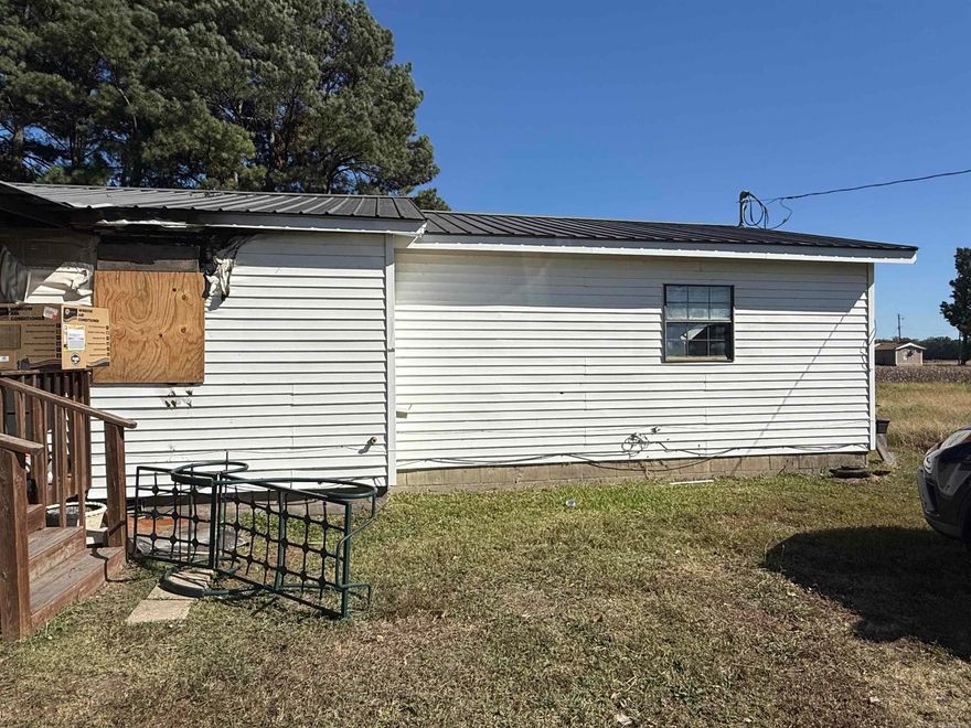 Approximately 3/4 of an acre of land that has a house that has burned.  Has water, septic and electricity, so build what you want after house is removed.