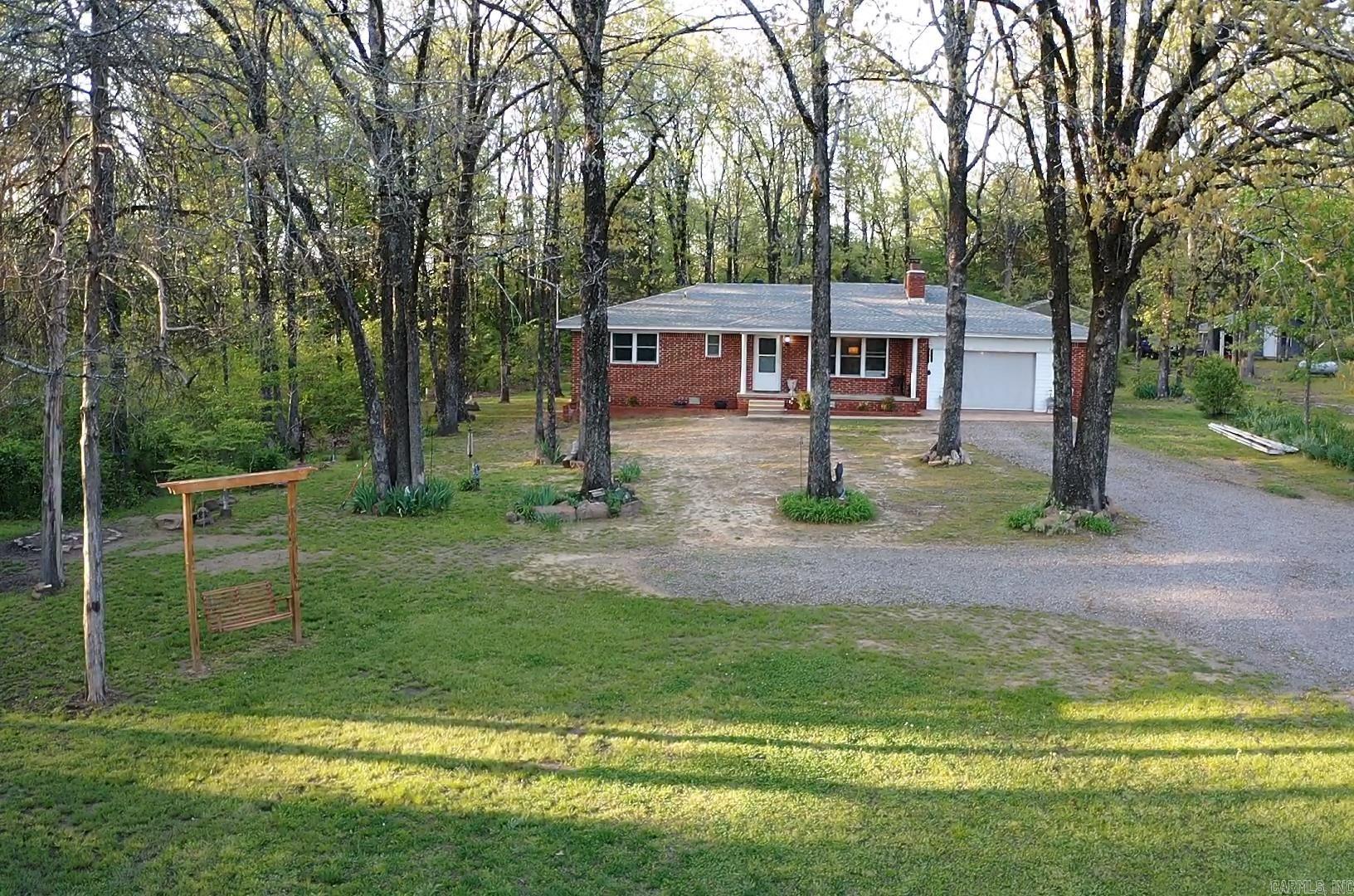 If you're looking for peace & quite just minutes from Searcy, this could be the one for you! This 2 bed, 2 bath house is nestled on a half acre of mature oak trees with a peaceful view from the back deck. It comes with a storage building for all of your extra belongings. The garage has been partially enclosed to a single car, could be turned into a bonus room if preferred. Call for showings, appointment only!