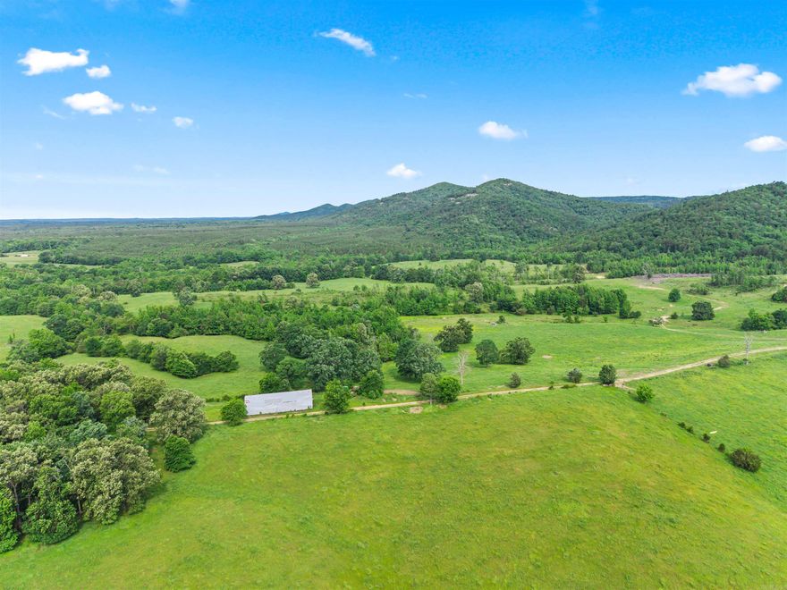 Rarely does a property this complete come to market. Located in the beautiful Lodi community, just 15 minutes from Glenwood in the Kirby School District, this 430± acre ranch borders the Ouachita National Forest and delivers the trifecta serious buyers demand — productive working ground, exceptional water, and spectacular views — all within a single boundary.  | THE LAND: Rolling pastures cross-fenced into multiple paddocks currently support 200+ head of cattle, with infrastructure in place to continue ranching from day one. Lush grass stands, mature scattered oaks for shade, and well-maintained interior roads make this a turn-key cattle operation. Multiple premium building sites — including two bluff-top locations with panoramic views of the Ouachita Mountains — invite the next owner to build a legacy home or hunting lodge without compromise.  | THE WATER: Self Creek, a year-round Ouachita Mountain stream with crystal-clear water running over a rocky gravel bottom, winds through the property with the seller owning both banks. A stocked pond adds a second water feature. In Pike County, year-round water of this quality is the most sought-after and hardest-to-replace asset a rural pr