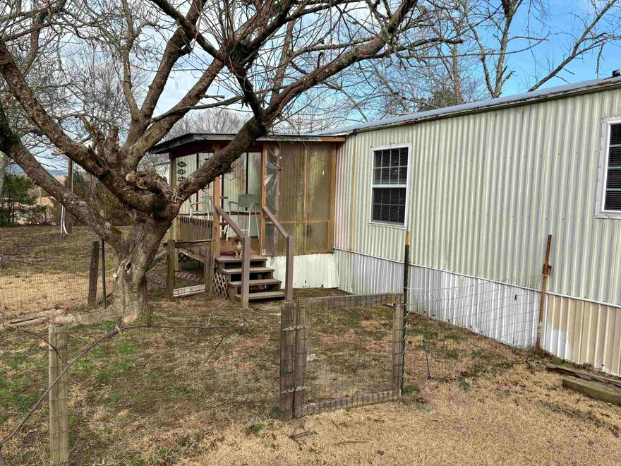 Mountain views, one acre plus lot with mobile sitting atop the hill, shop, peach trees, lot covered with hardwoods, raised garden spot, storm shelter, comfortable covered front and back porches, owned propane tank that is full, new back steps,16x80 mobile home,  3 bedrooms, 2 baths, remodeled throughout, damaged floor joists replaced, floors replaced with 3/4" plywood, new flooring, new double pane windows, new high toilets, new bathroom sinks, fresh paint. Turn right from driveway and be on Ouachita River in five minutes, ten minutes to Ouachita Lake boat landing, thirty minutes to Hot Springs Village. Turn left and be on Ouachita River in three minutes, seven minutes to nearest Dollar General in Pencil Bluff, a local grocery store with delicious cheeseburgers.