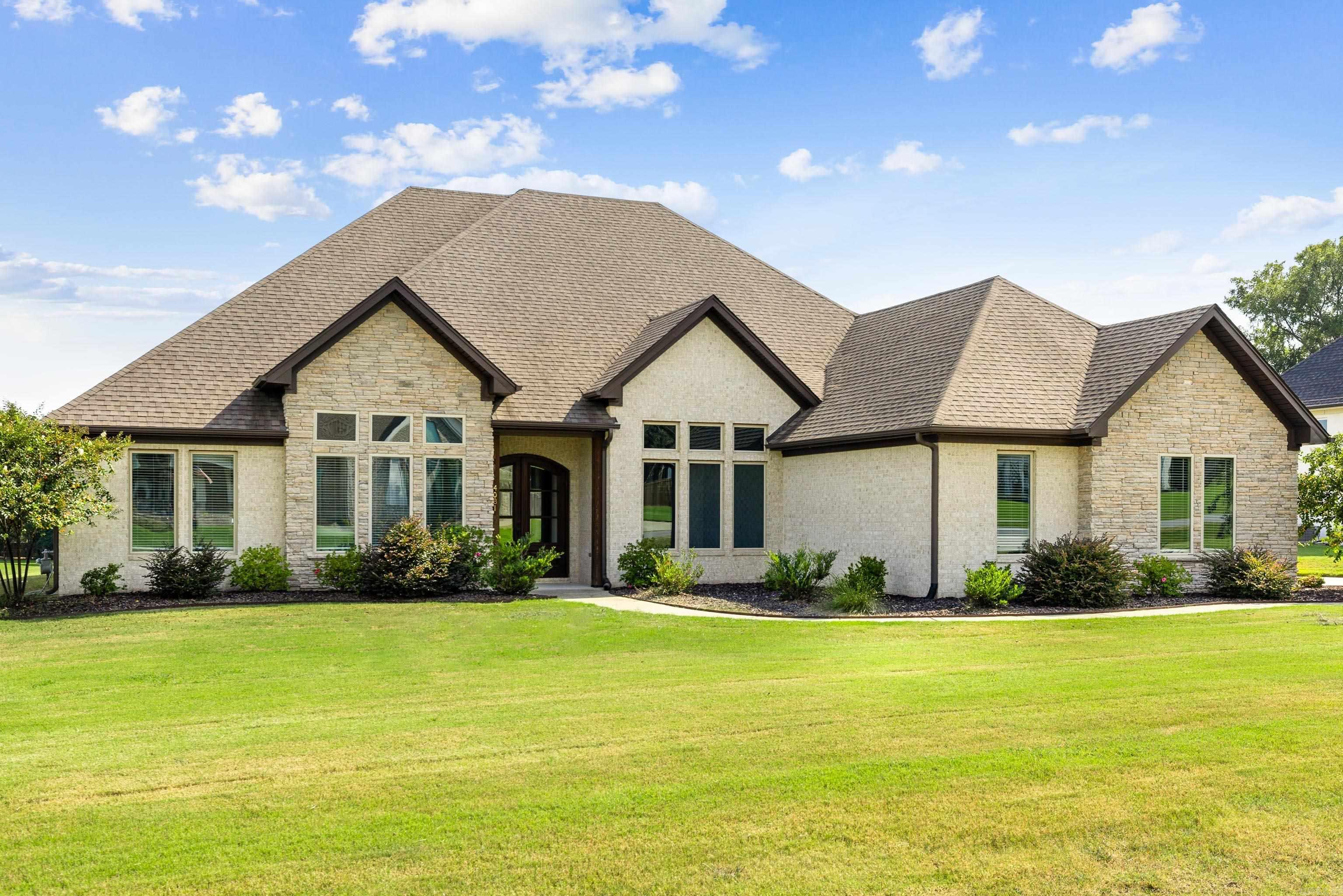 BEAUTIFUL ONE LEVEL HOME ON ONE ACRE!! Custom built by Schrader Homes, this residence features 4 bedrooms PLUS a media room. The primary suite includes a trey ceiling, freestanding tub, custom tile shower, and walk-in closet. The open kitchen features a built-in commercial-sized refrigerator/freezer, walk-in pantry, breakfast bar and wine fridge. Enjoy formal dining, under-cabinet lighting in all bathrooms, and a covered porch with a wood-burning fireplace. Spacious media room perfect for movies and games. Additional features include a mudroom with bench and hooks, a 3-car garage, and a tankless hot water heater. Great location, Bryant schools, and Springhill Elementary!