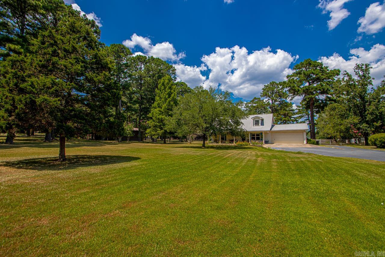 Country oasis in the middle of town! With the addition of the new Bryant Parkway you are seconds from the Interstate! Located on over 2 acres in the heart of Bryant sits this 3 bed 2 bath home. This home has been meticulously taken care off. The downstairs features a spacious and cozy living room with a gas log powered stove. The all electric kitchen has everything you need with a great view over the sink to the back yard. The main level also features a laundry room and primary bedroom and bath. The upstairs features 2 large bedrooms with tons of storage and a Jack n Jill style bath between them. All of this with a two car garage and metal roof. The yard features large mature pine trees and extra landscaping. The back yard is fully fenced. New septic system in 2014. 30x40 shop tops this yard off, complete with electricity. Properties like this aren't on the market often. Jump on the opportunity to own your private country oasis seconds from town!