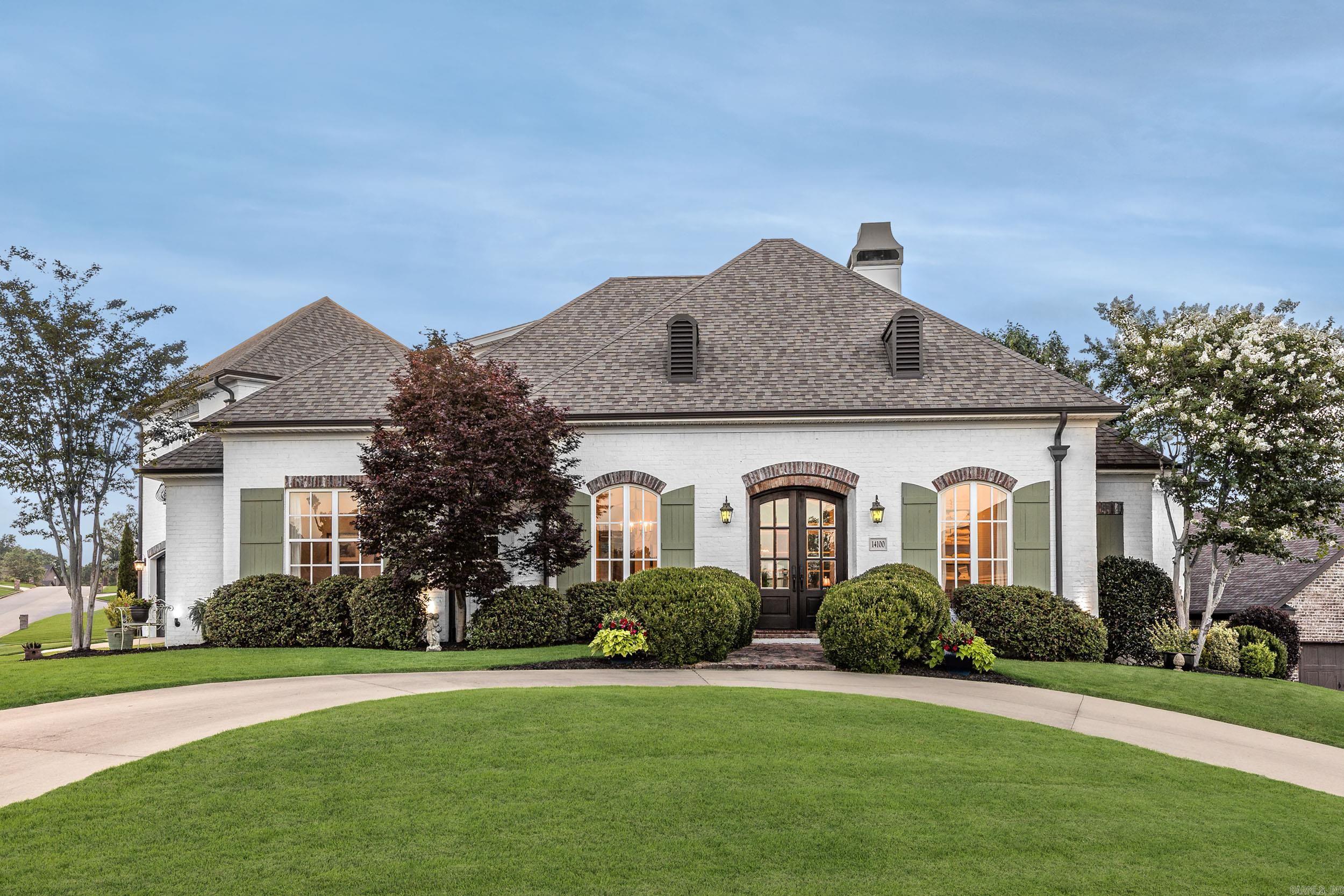 Timeless French Country home in the highly desirable Woodlands Edge neighborhood. A circle drive welcomes you to charming double entry doors. Inside, enjoy a formal dining room, a spacious great room with 12 ft. ceilings a wood-burning fireplace, built-ins, and views of the private backyard. The chef’s kitchen features double ovens, custom cabinetry, large island, oversized pantry, office nook, and locker area. The main-level primary suite offers tray-vault ceiling, sitting area, spa-like bath with soaking tub, 2 vanities, and an expansive walk-in closet. A second bedroom or office with walk-in closet also on main level. Upstairs includes 2 bedrooms, with walk in closets a full bath, and a versatile bonus room—perfect as a media room, gym, or playroom. Enjoy outdoor living with a covered and extended patio, outdoor kitchen with plumbed gas line, and custom swing (conveys). The enchanting courtyard is a must see. The new owner will enjoy the oversized garage with 2 storage areas. The neighborhood offers pool, park, tennis courts and miles of trails. So many extras in this home you have to see for yourself! Schedule your private tour today!