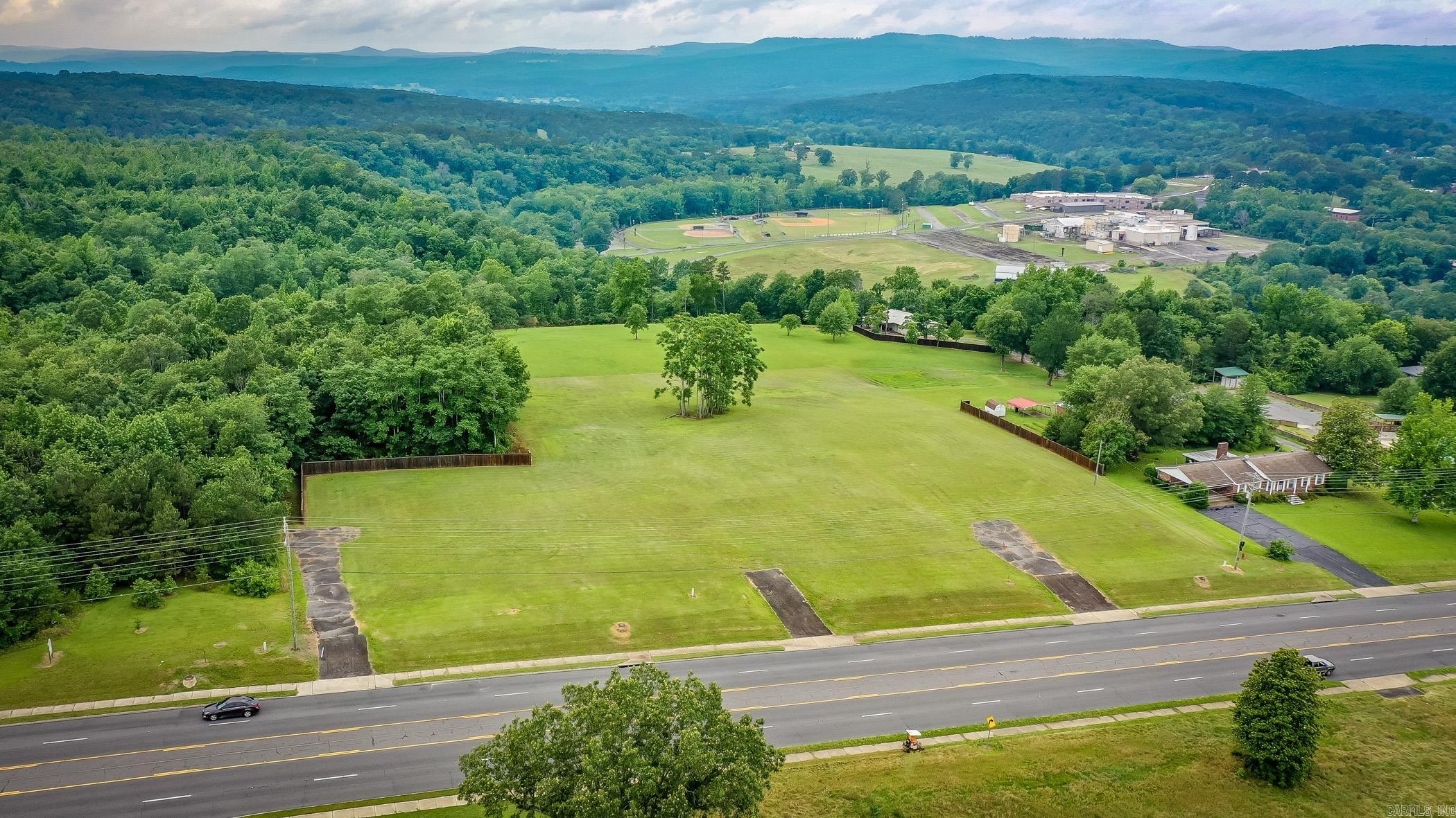 Don't miss this exceptional real estate opportunityā11.79 acres of prime land located directly on Highway 65, offering high visibility and a strong daily traffic count. This versatile property features multiple entrances and is partially fenced, with breathtaking views of the surrounding mountains, pastures and baseball fields. With its strategic location and expansive space, itās ideal for a wide range of development possibilities including a subdivision, restaurant, hotel, retail center, or commercial business. Donāt miss your chance to invest in one of the most desirable and high-potential tracts in the area.