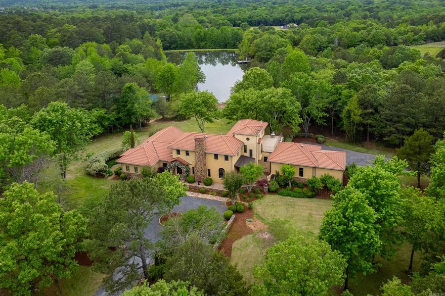 Breathtaking estate on 6.64 gated private acres w/3 acre pond & 30x75 Bardominium w/3 bay shop, living quarters, outdoor kitchen & stone fireplace. You will forget you are in Little Rock when you drive up the circular drive to this gorgeous Tuscan inspired villa. The main level w/open living/dining rooms, remodeled kitchen w/ GE Cafe Appliances including sonic ice machine, wall oven, microwave & warming drawer. Natural stone countertops & copper vent. Primary bedroom w/sunroom overlooking the beautifully landscaped yard & stocked pond. New primary bath w/double vanities, walk in shower, pvt. water closet & jetted tub. Prmary has flex room that can be used as office or living space. Spacious walk in closet. Main level also has kitchen/living/dining, huge laundry w/sink, wine cellar, covered patio & 2 half baths. Upstairs w/ 2 guest bedrooms, living room w/ wet bar & private terrace. New guest bath w/double vanity. New Barndominium w/open living, dining, kitchen & bath. A glass garage style door opens to covered 20x30 patio w/outdoor kitchen & stone fireplace. Fully equipped gym & 3 bay shop. 3/car rear garage & new paved road. Generator.