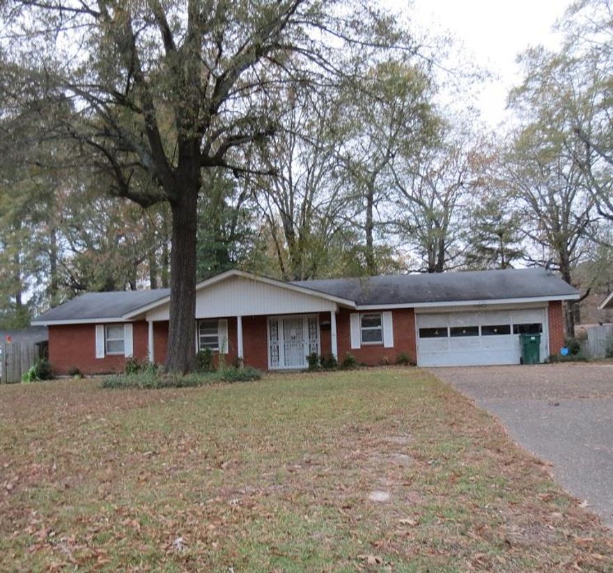 Brick home located in neighborhood close to hospital.  Two living areas, Fireplace, sun porch, large laundry room, garage has extra storage areas, outside storage buildings.  Make this your new home, cheaper than rent!!  Call me today for more details.  Taxes are before Homestead Credit. **Agents see Remarks**