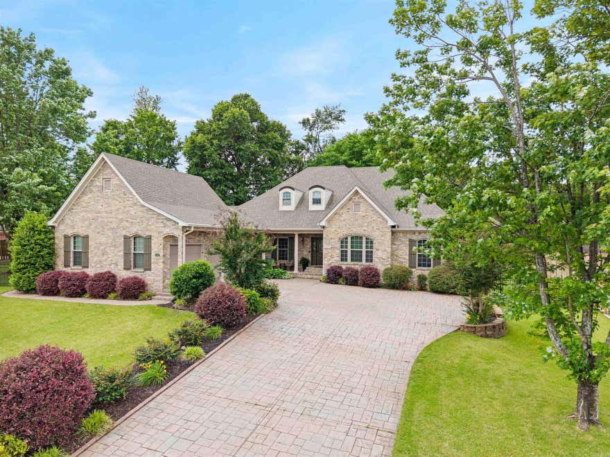 This beautiful home in Hurricane Lake Estates offers the perfect mix of style, comfort, and well-planned updates, all complemented by a peaceful lake view. From the moment you arrive, the stamped driveway and well-kept landscaping make a strong first impression. Inside, you’ll find 10-foot ceilings, updated LVP flooring, a cozy stone fireplace with a new mantle, and a formal dining space that’s ideal for both everyday living and hosting guests.  The layout lives primarily on one level, featuring a spacious primary suite with an attached office, laundry access, and generous living space, along with three additional bedrooms on the main floor. Upstairs, a versatile bonus room provides the perfect spot for a playroom, media space, or home office.  The garage and 8x10 shop both feature durable epoxy flooring, and recent upgrades include a new HVAC system, hot water heater, added bonus room, and a whole-home generator. Step outside to an oversized backyard designed for privacy and relaxation, complete with a covered porch, mature trees, and a fully fenced yard with wrought iron accents in the front and wood fencing surrounding the rest.  AGENTS SEE SHOWING REMARKS