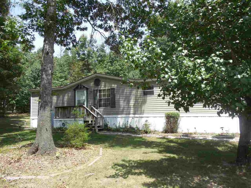 Doublewide Manufactured home with a lot of extra's. Located end of cul-de-sac, paved drive with double carport, RV parking, 3 storage sheds (1 with electricity). Home sets on .93 acre lot, mature trees and private backyard. H/A 2011, Roof 2010,appliances 2012, 12x28 roofed side porch with hot tub. Split floor plan with formal dining & breakfast room leading to covered porch. Master suite with walk-in closet, garden tub with separate shower. Ceiling fans, pantry, skylights & gas log fpl. Agents see remarks